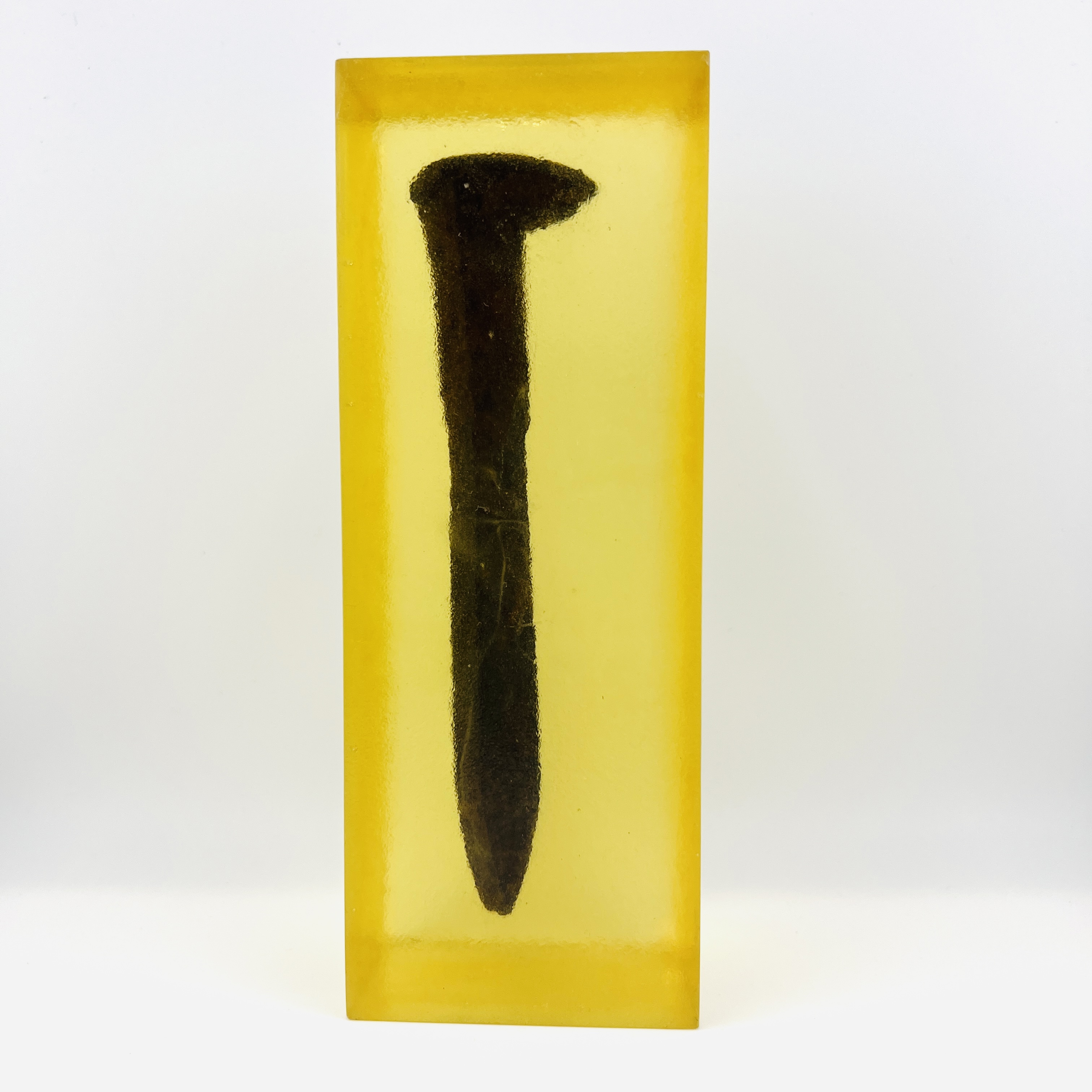 Original Pacific Coast railroad steel spike resin display block in amber color