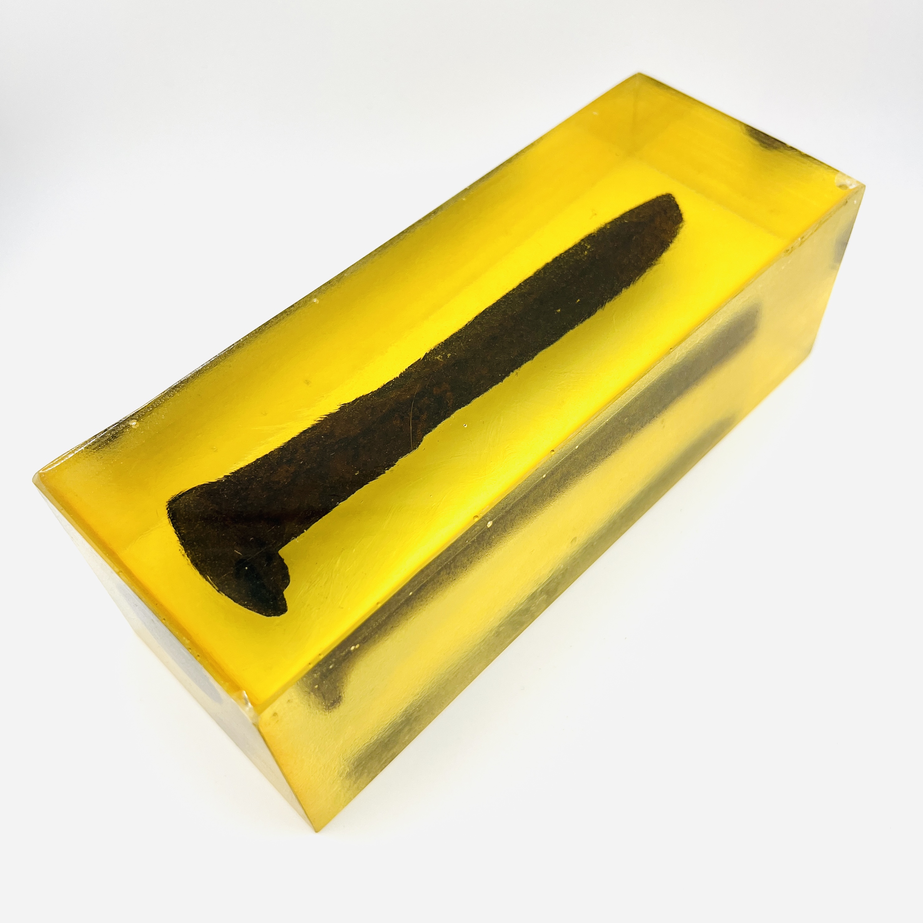 Original Pacific Coast railroad steel spike resin display block in amber color