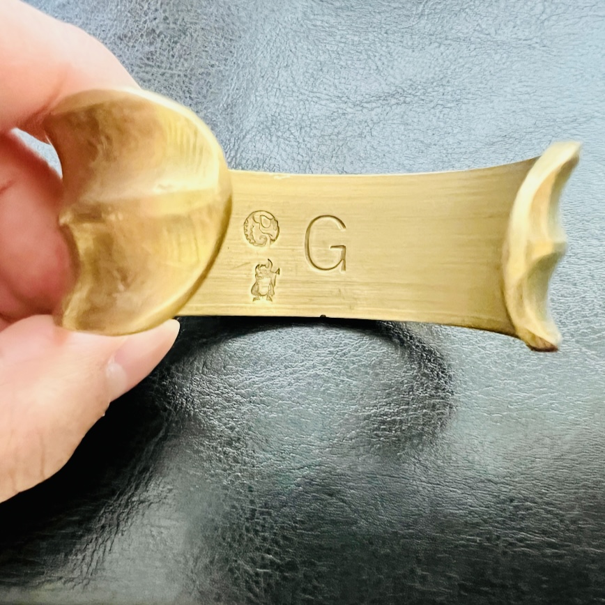 Brass carved skull wide bangle