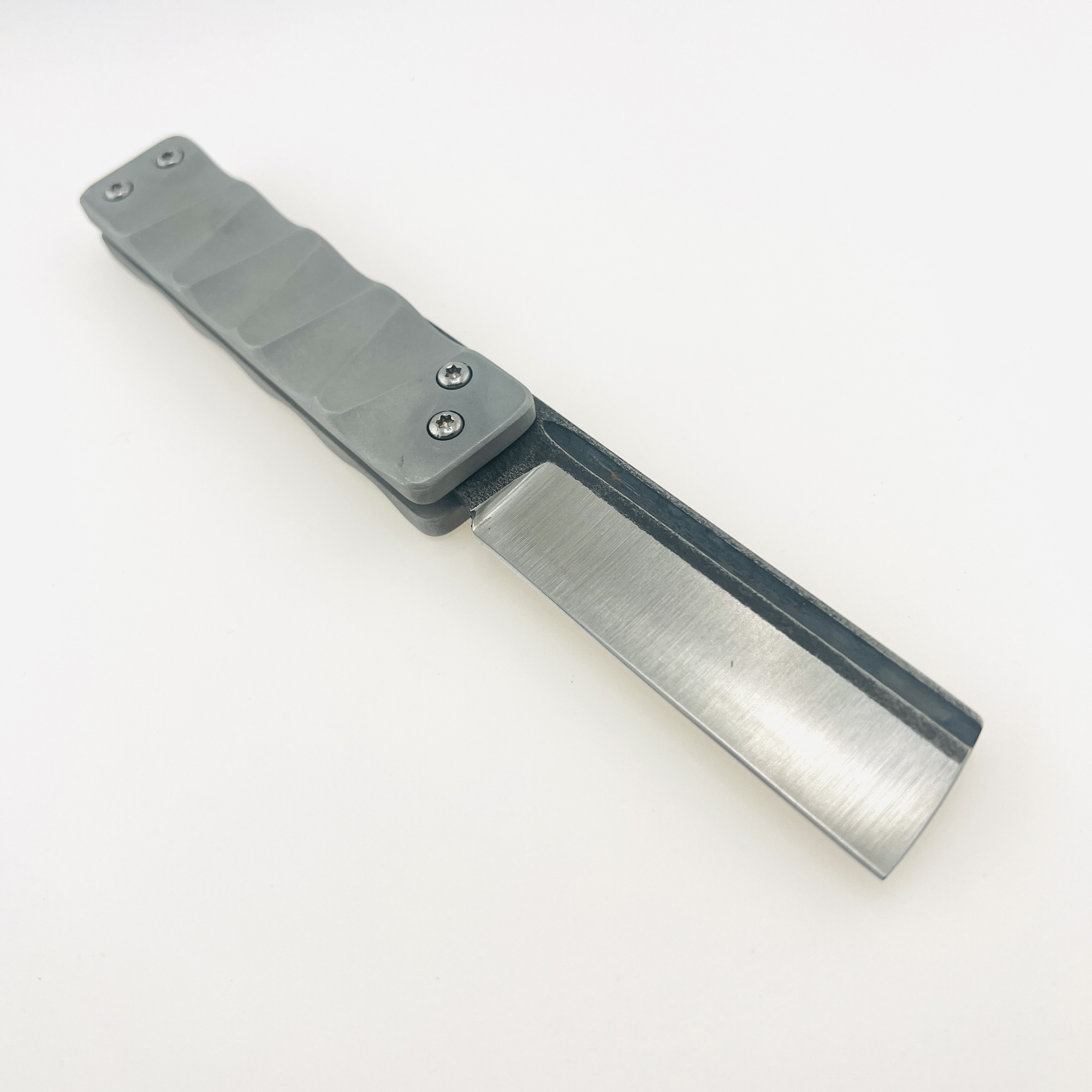 The Ruler flip razor in D2 steel and space aluminum