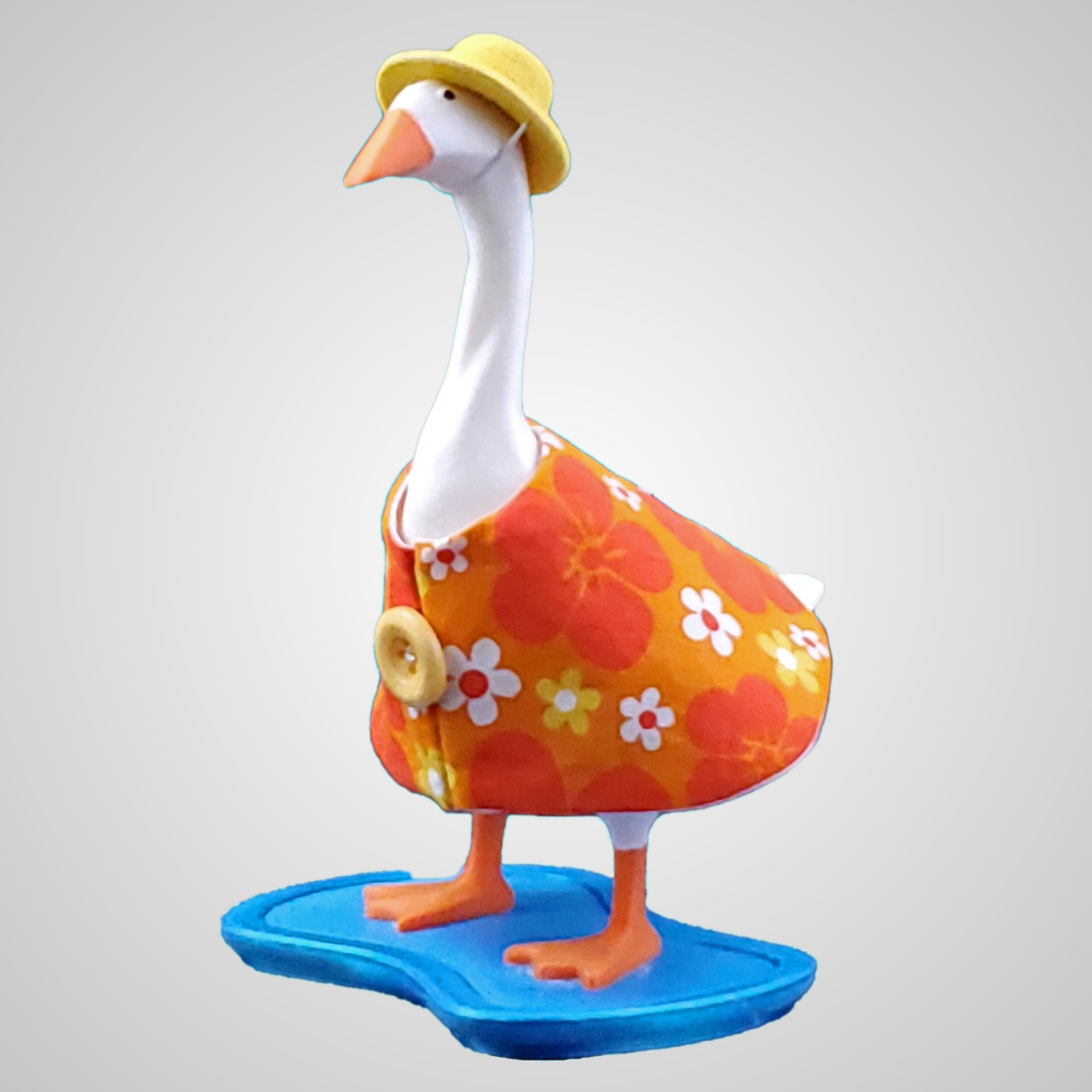 Orange and Yellow flowered desk goose dress with a felt hat.