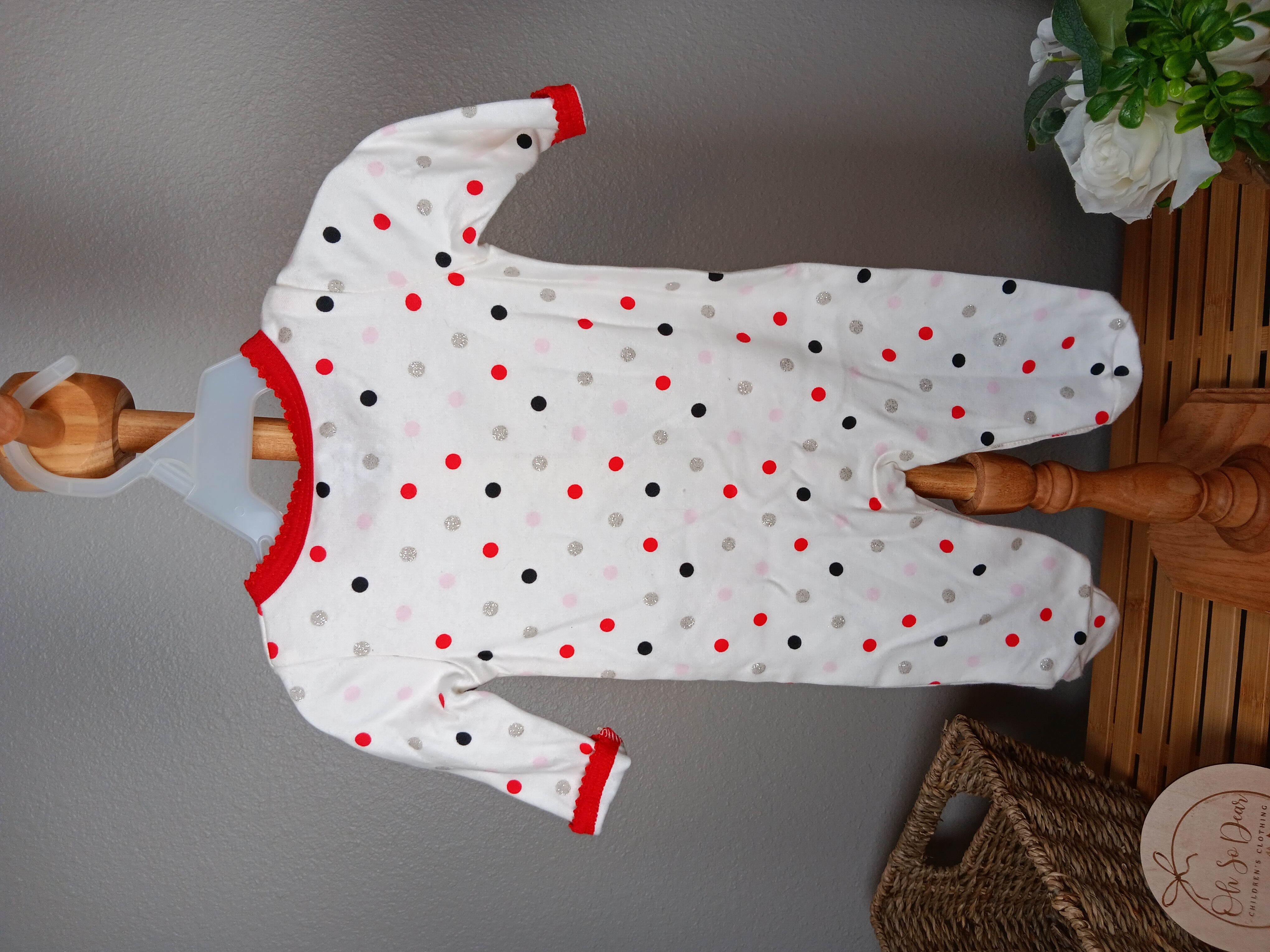 Polka Dot Baby Onesie Cozy cotton sleepwear with cute red bow details