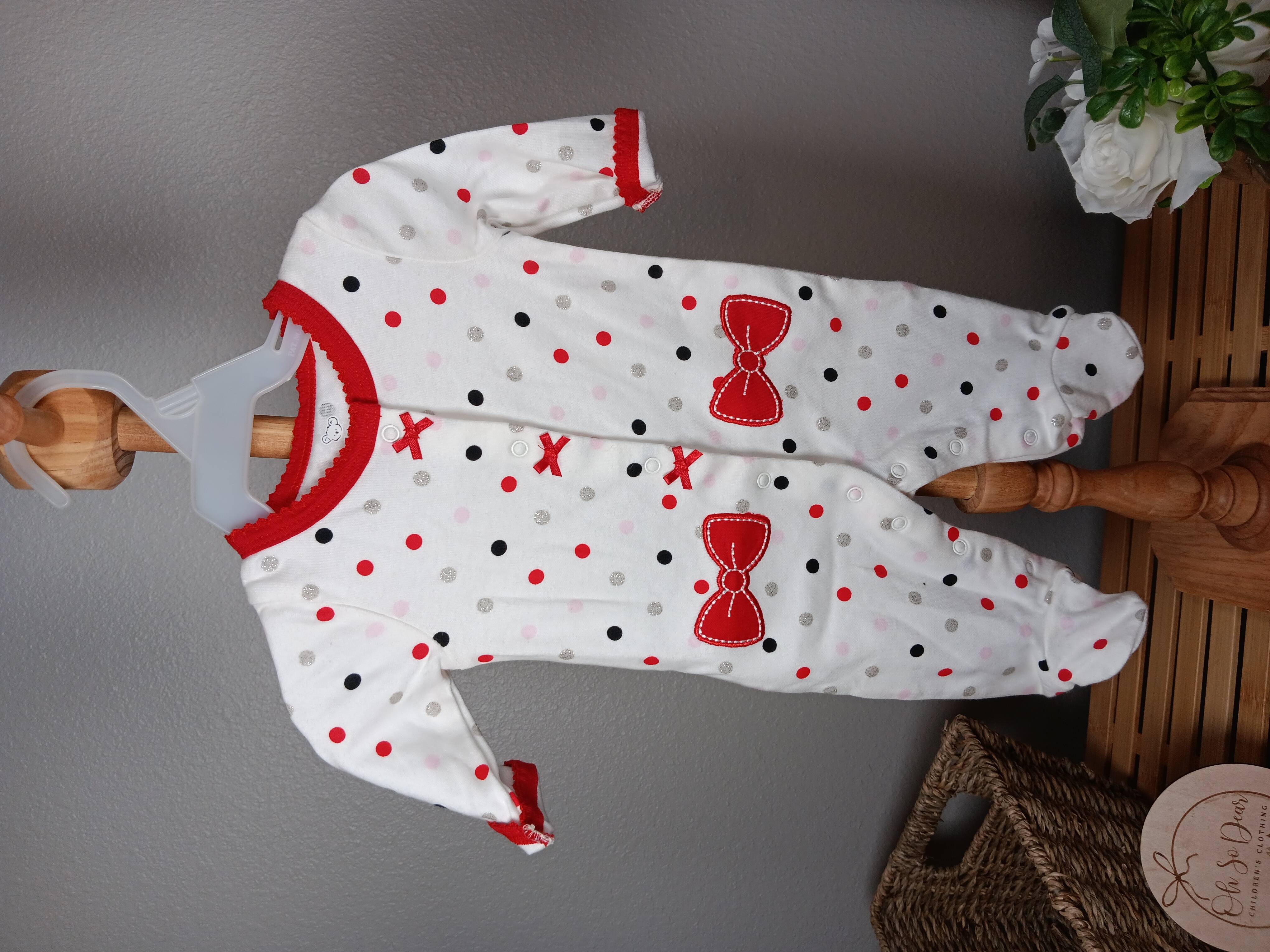 Polka Dot Baby Onesie Cozy cotton sleepwear with cute red bow details