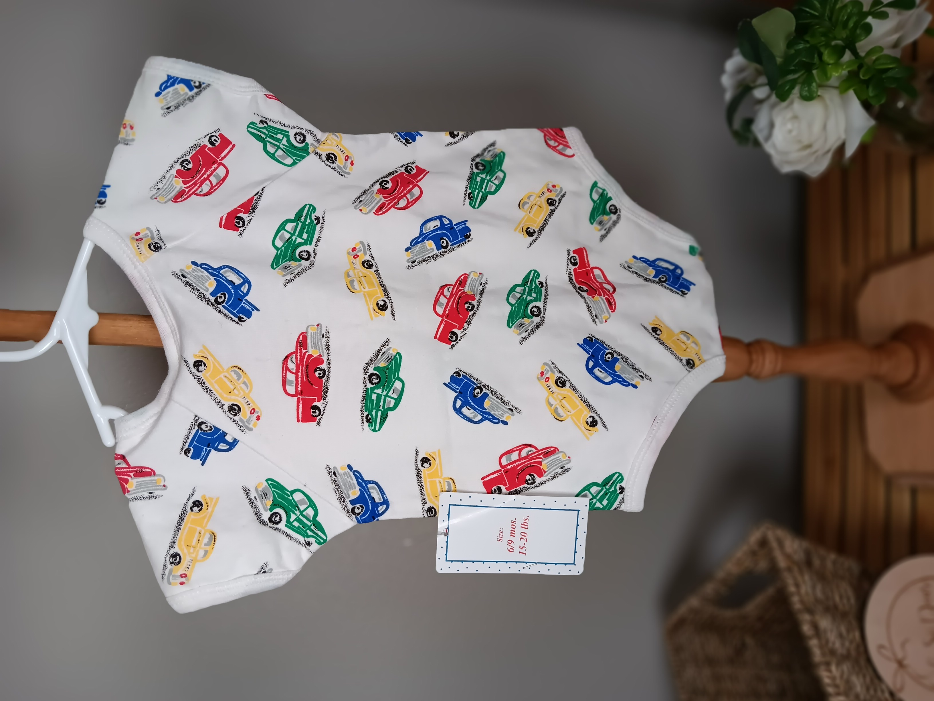 First Impressions brand Colorful Car Print Soft cotton bodysuit featuring playful car patterns for infants with booties size 6 to 9 months