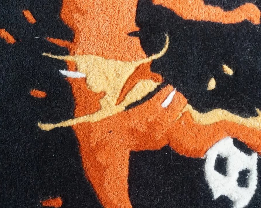 Hand Tufted Football Player Wool Rug  in vibrant orange, set against a striking dark backdrop