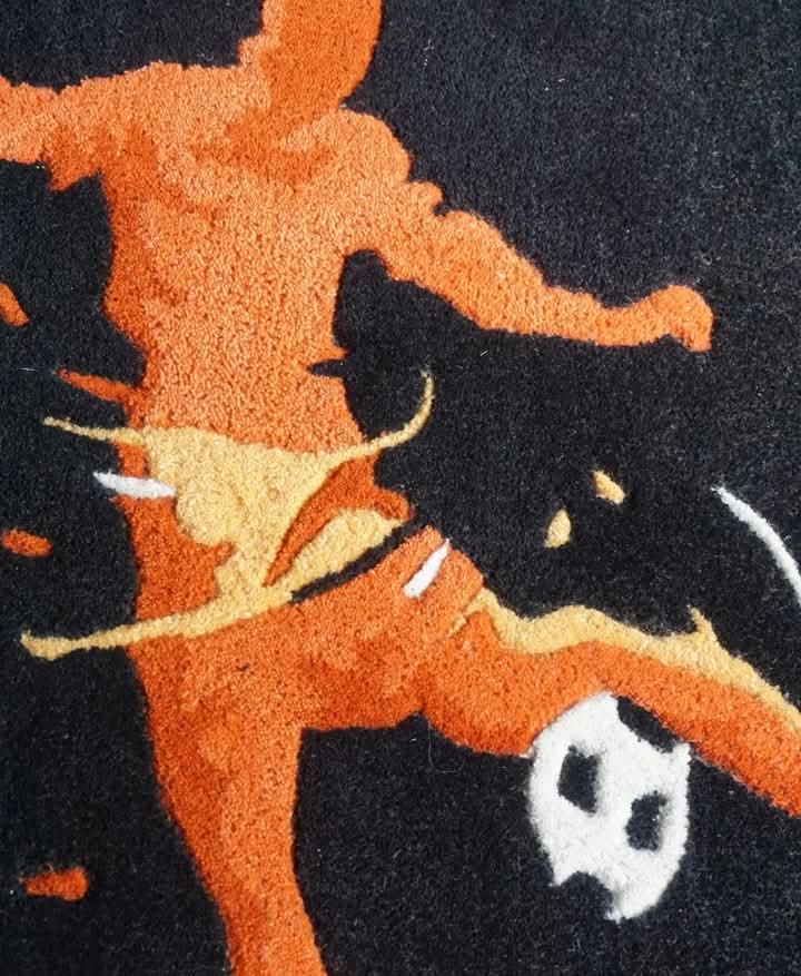 Hand Tufted Football Player Wool Rug  in vibrant orange, set against a striking dark backdrop