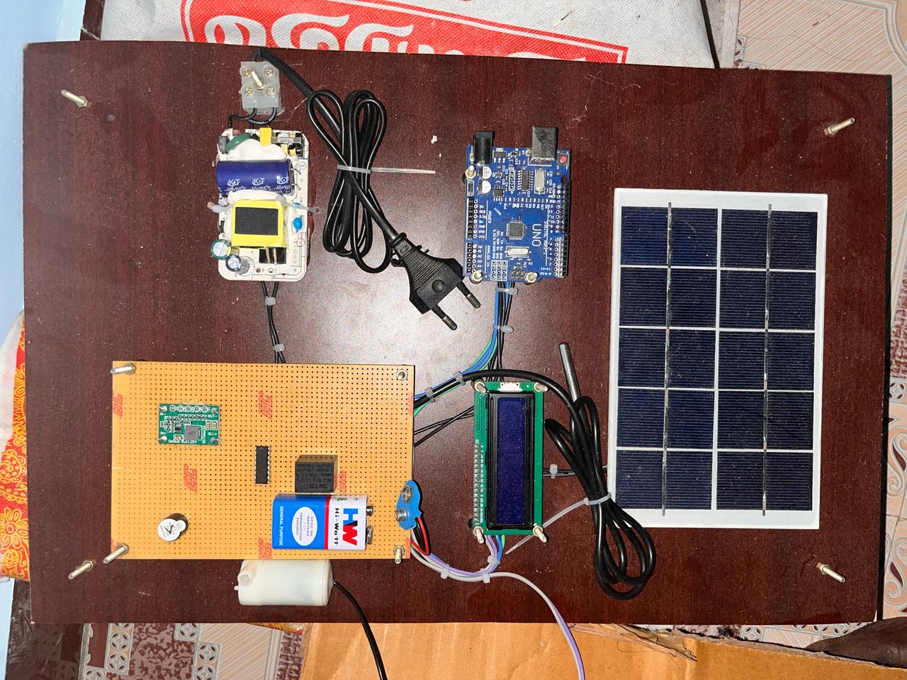 AutoClean: Solar Panel Cleaning System Based on Temperature and Water Pump