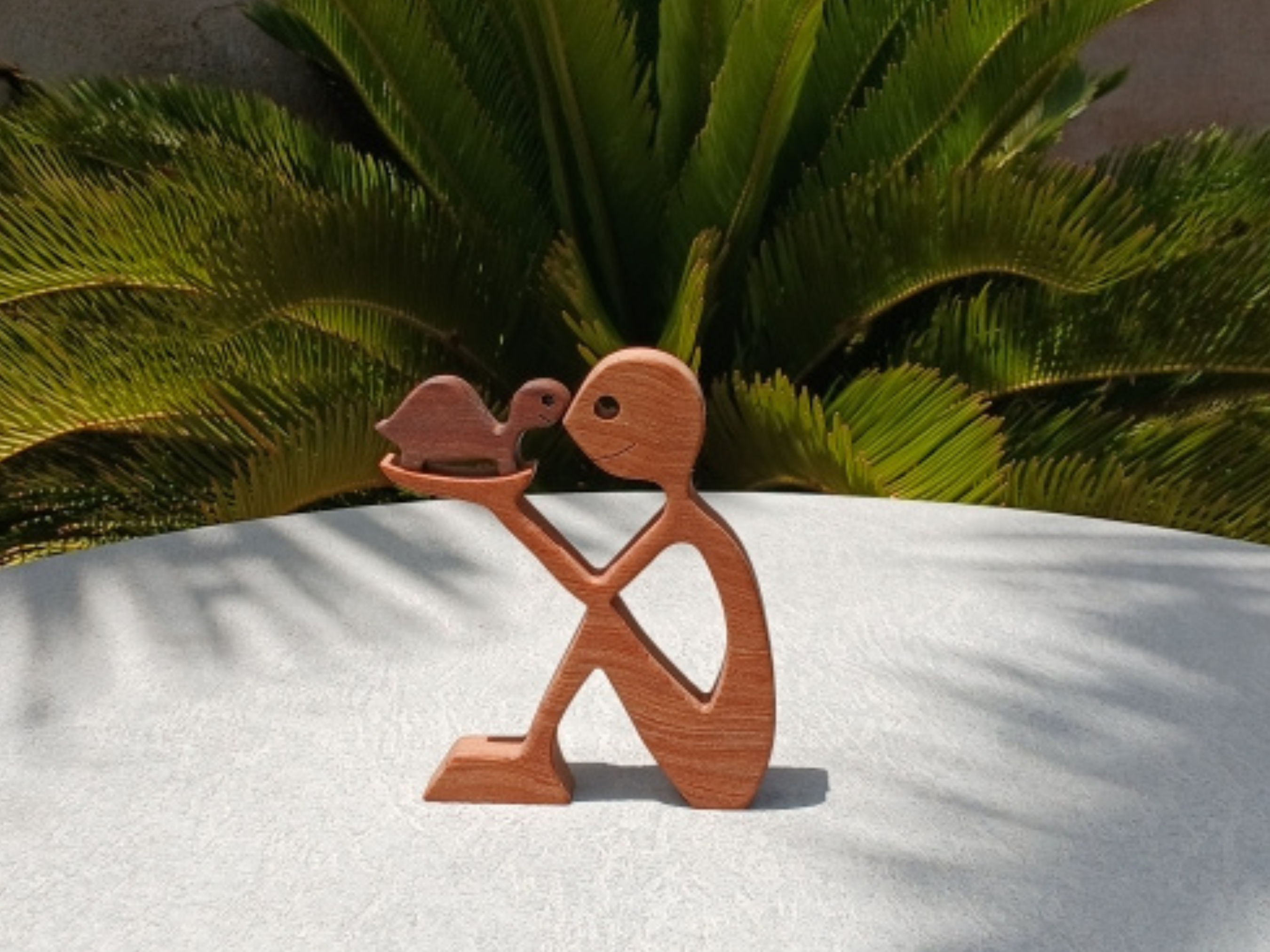 Man Holding Turtle Figurine