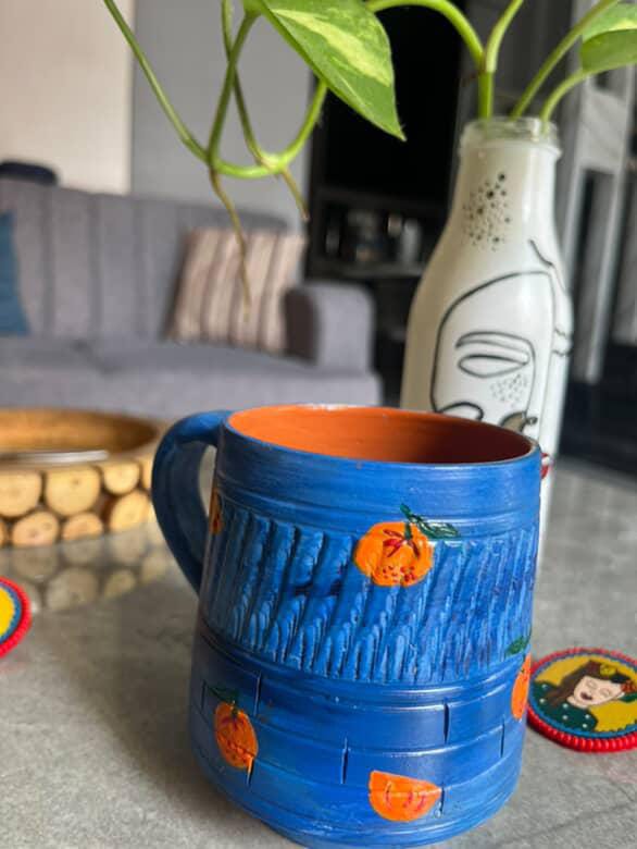 Hand-Painted Blue Terracotta Mug with Orange Motifs – ₹675