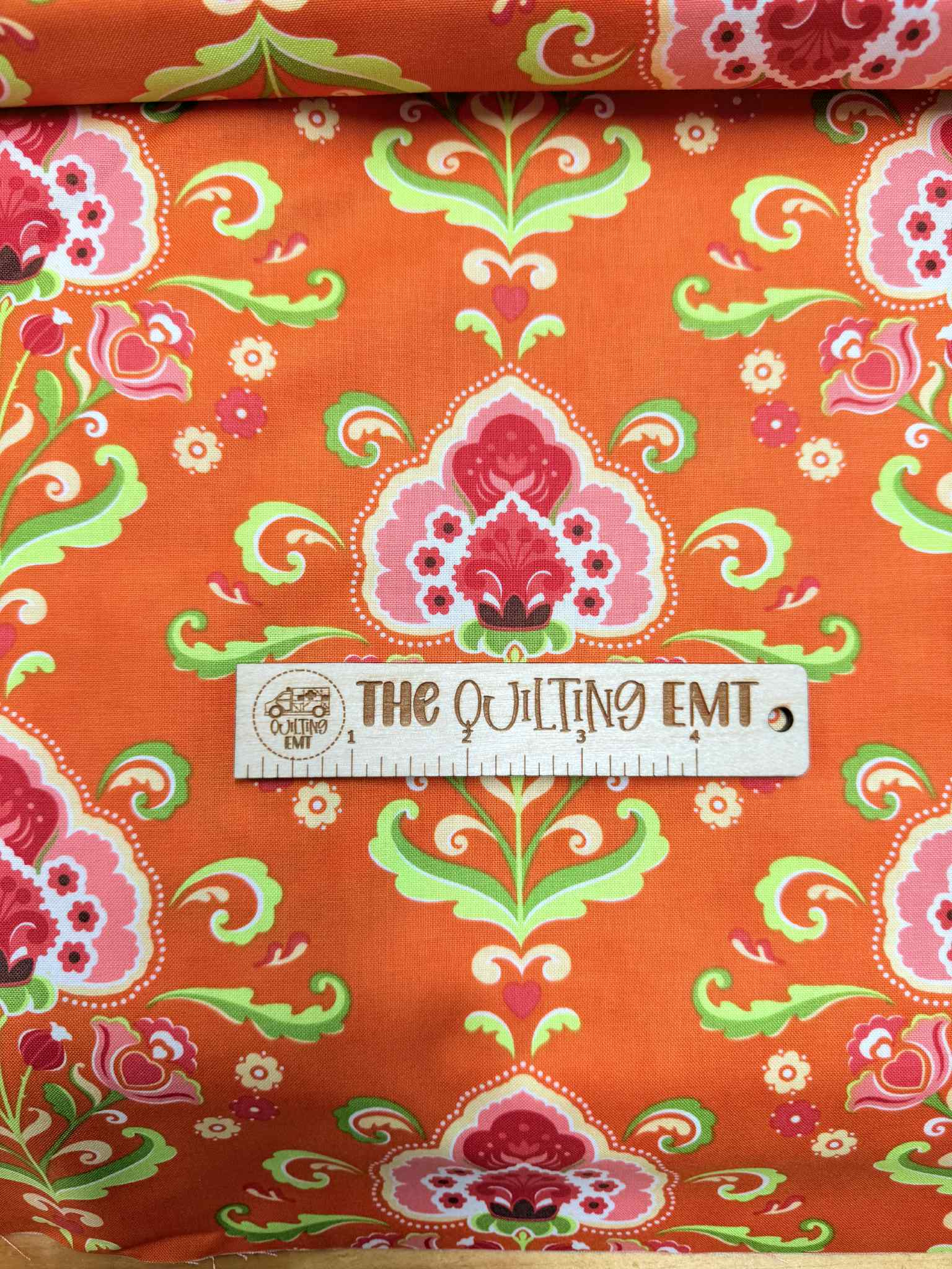 "Fancy" by Lily Ashbury for MODA cotton fabric featuring Orange background with Pink, White, Green Red and Yellow floral design 