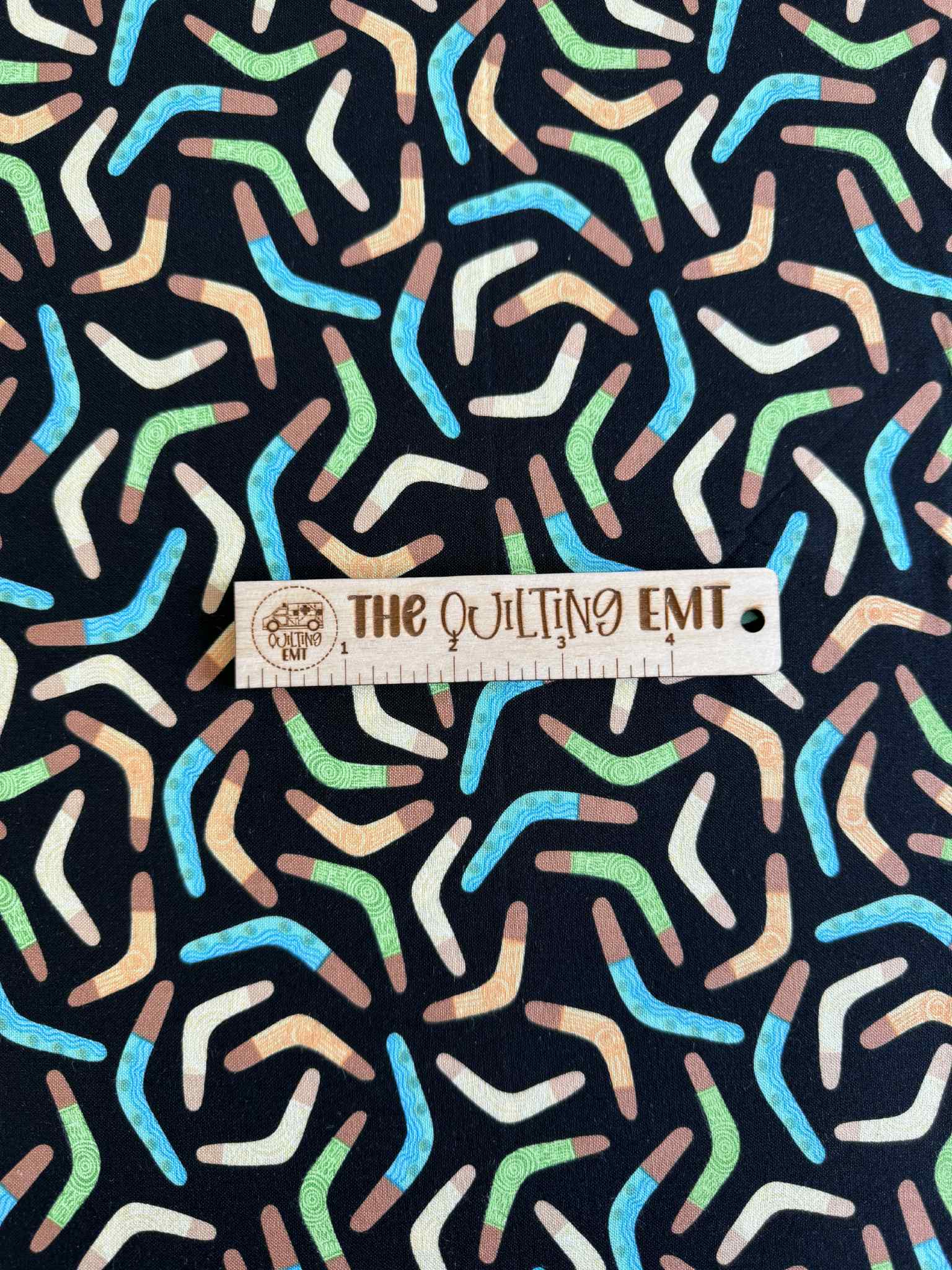 Boomerang cotton fabric with green, blue and brown boomerangs
