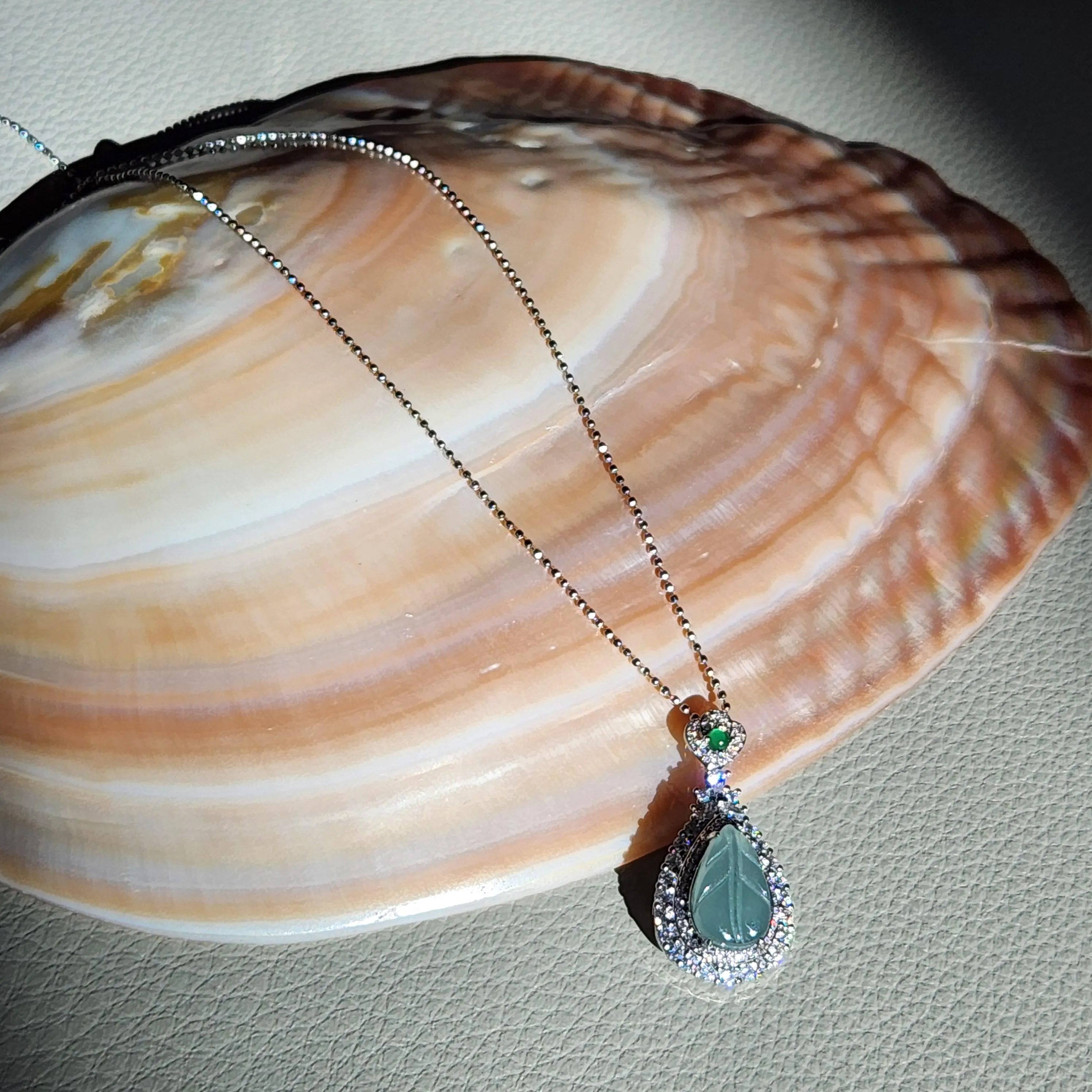 Blue icy translucent Jade leaf pendant set in silver  • Blue Burmese jade jewelry with cubic zirconia • 