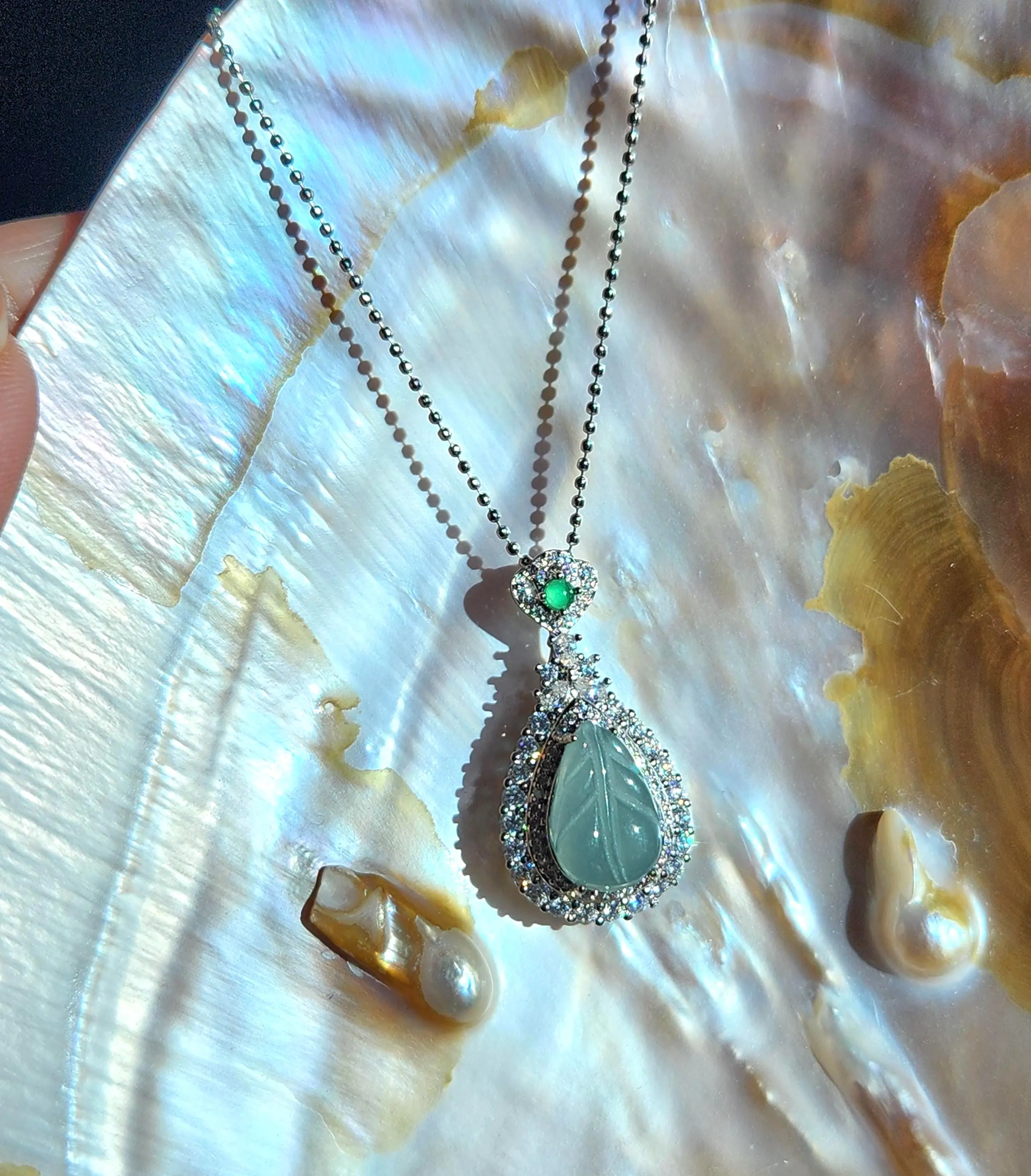Blue icy translucent Jade leaf pendant set in silver  • Blue Burmese jade jewelry with cubic zirconia • 
