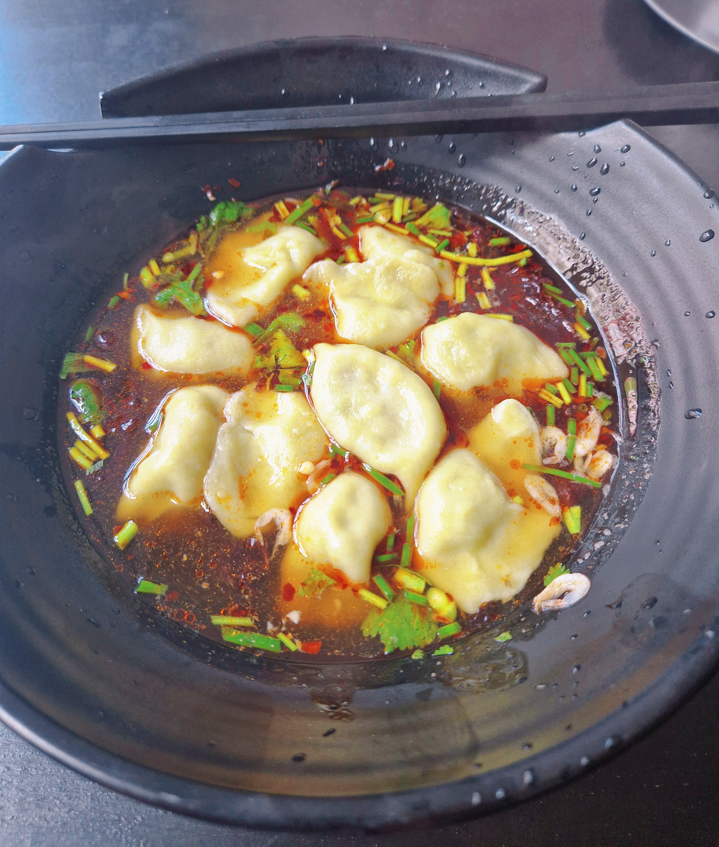 Vegetarian dumplings in sour & spicy soup