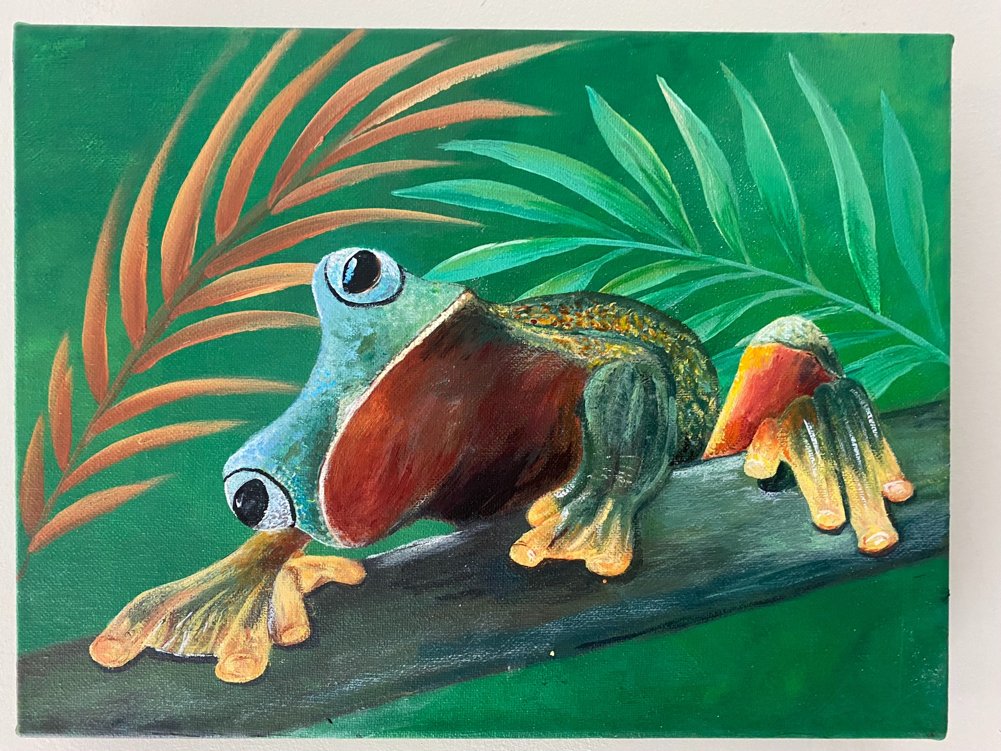 Green Tree Frog clinging to a branch against a vibrant green background