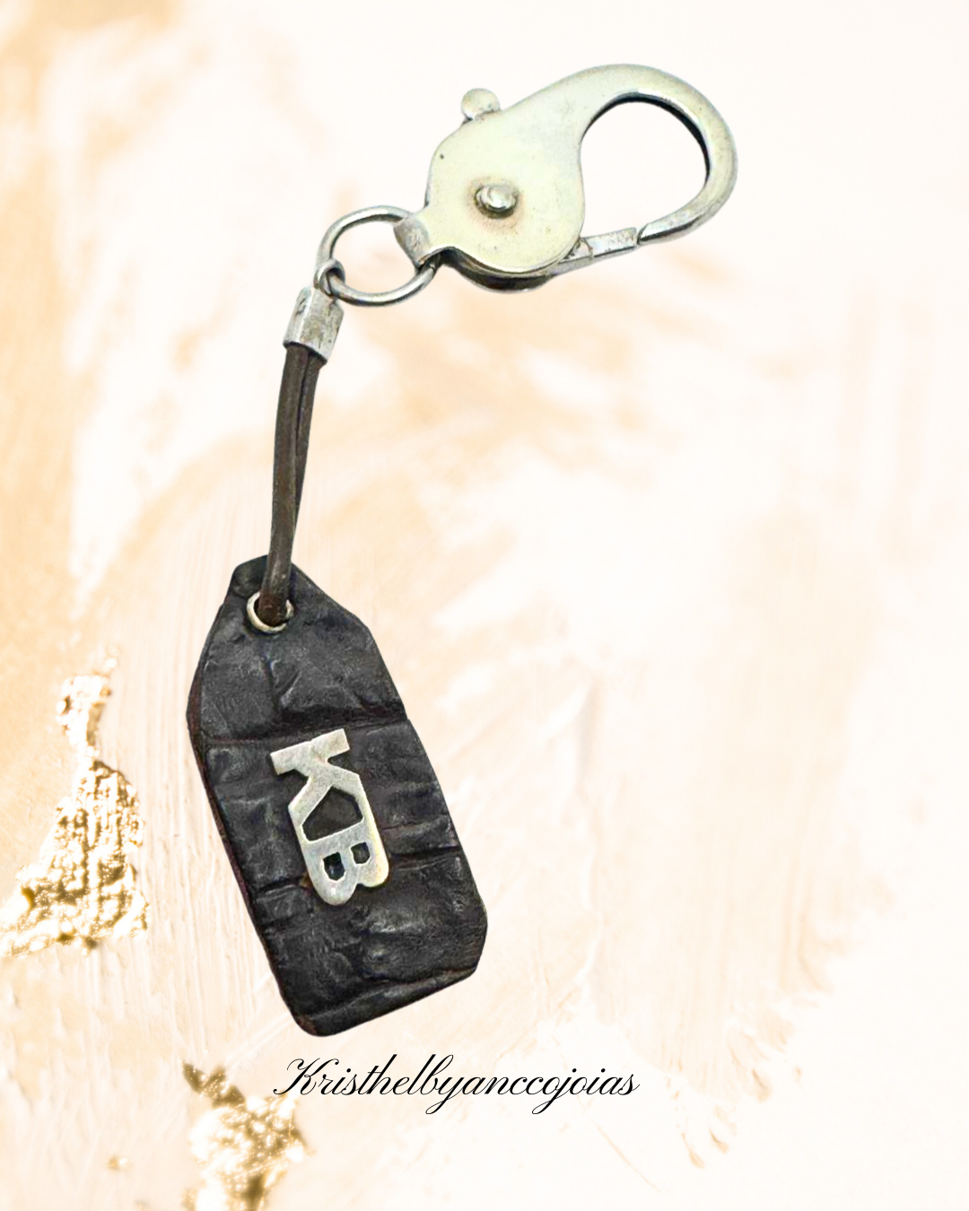 Este chaveiro em prata 950, com couro legítimo de jacaré.