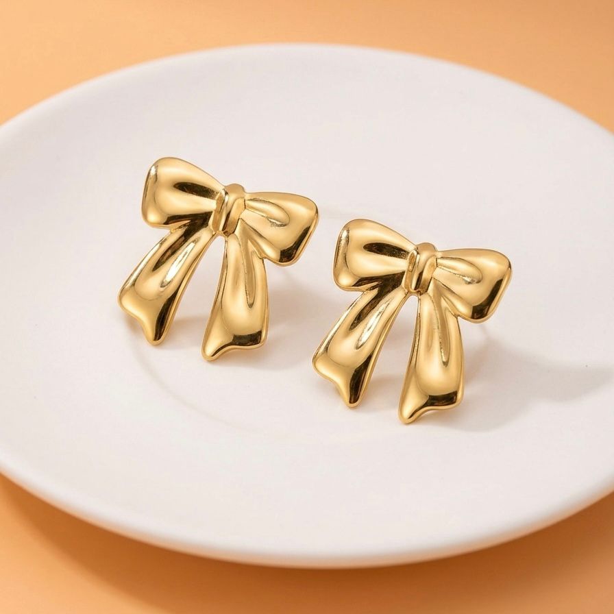 Aretes de moño dorado