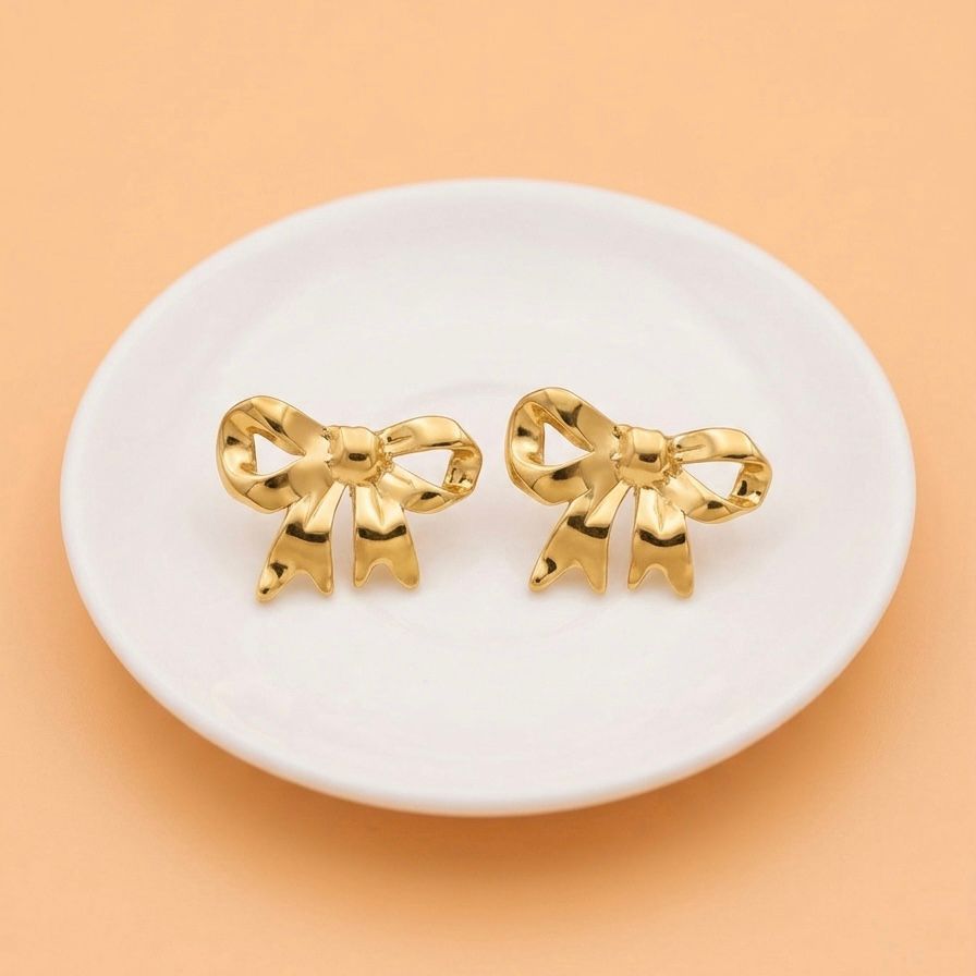 Aretes de moño dorado