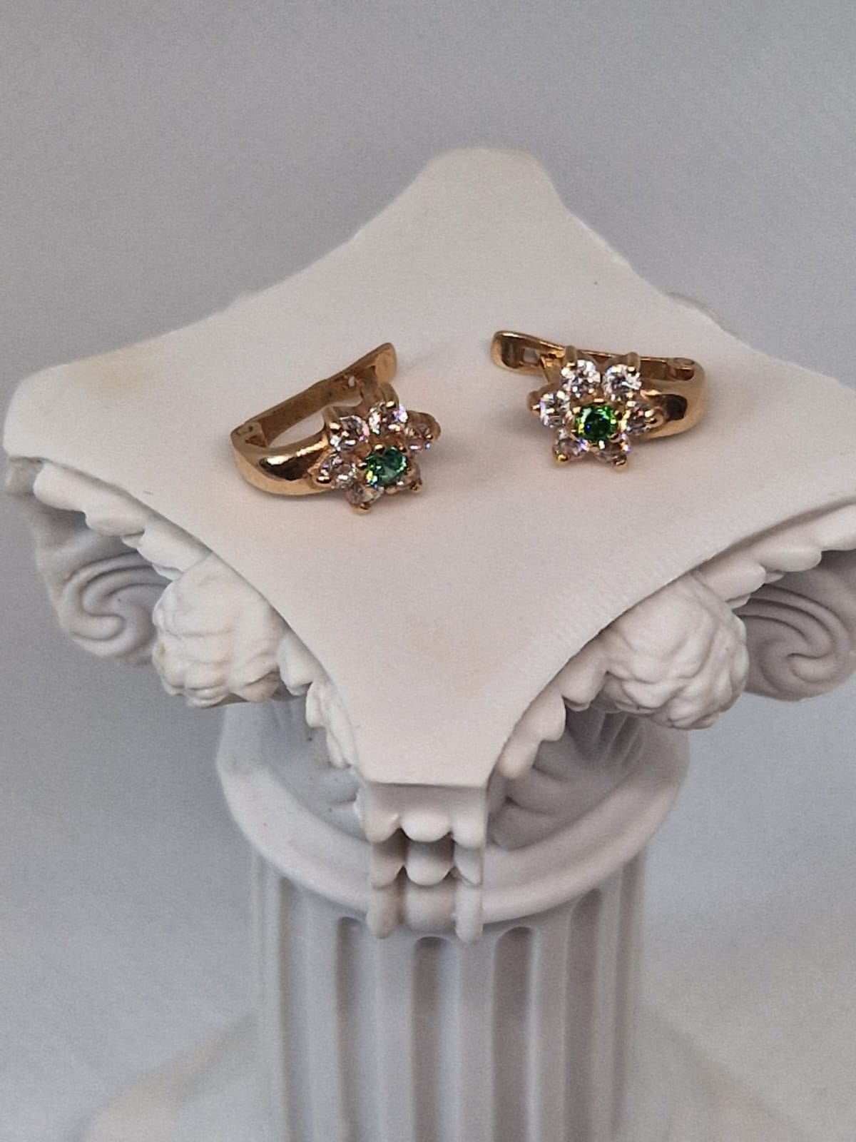 Gold earrings with green gemstone