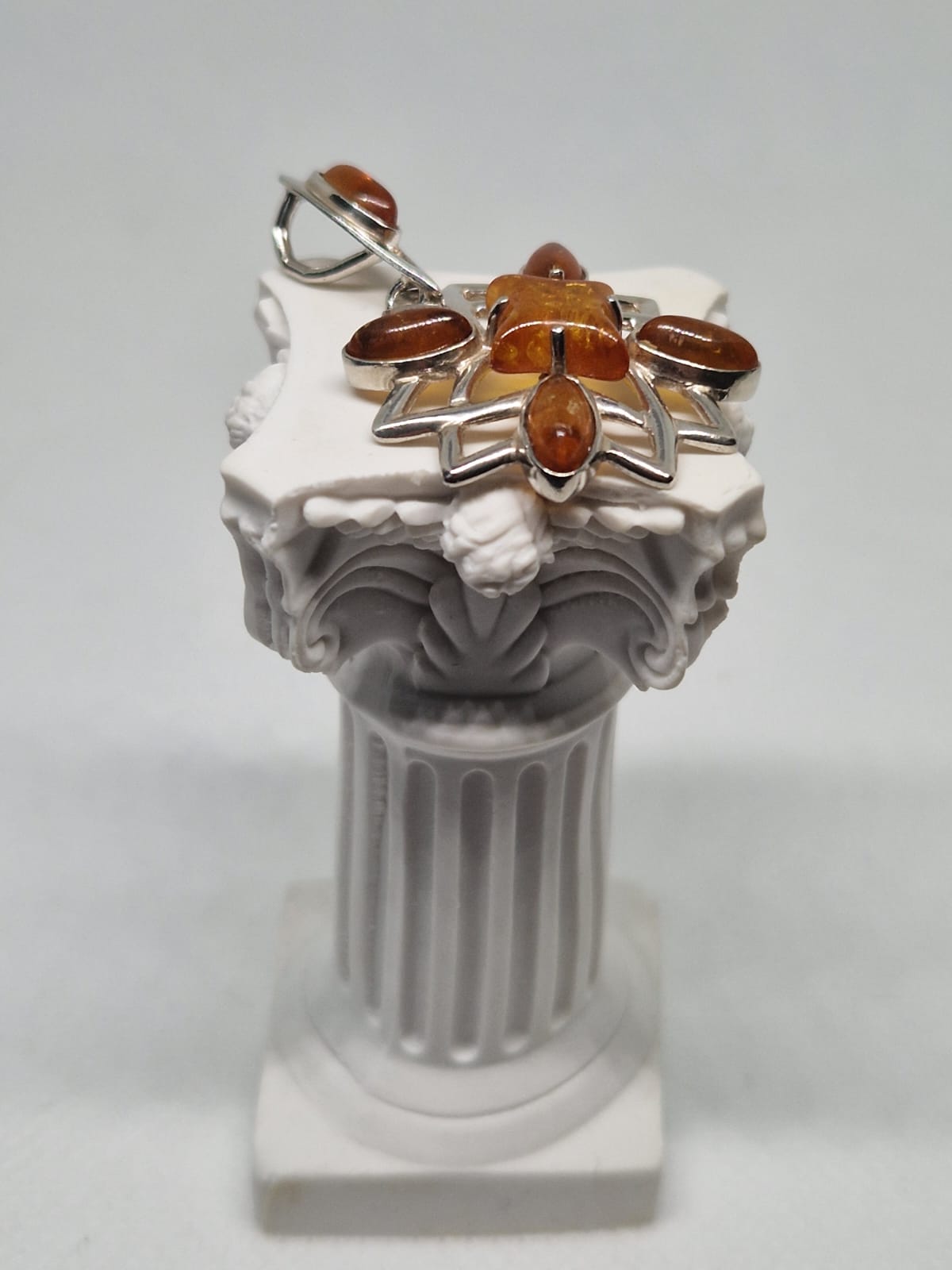 Silver pendant with amber