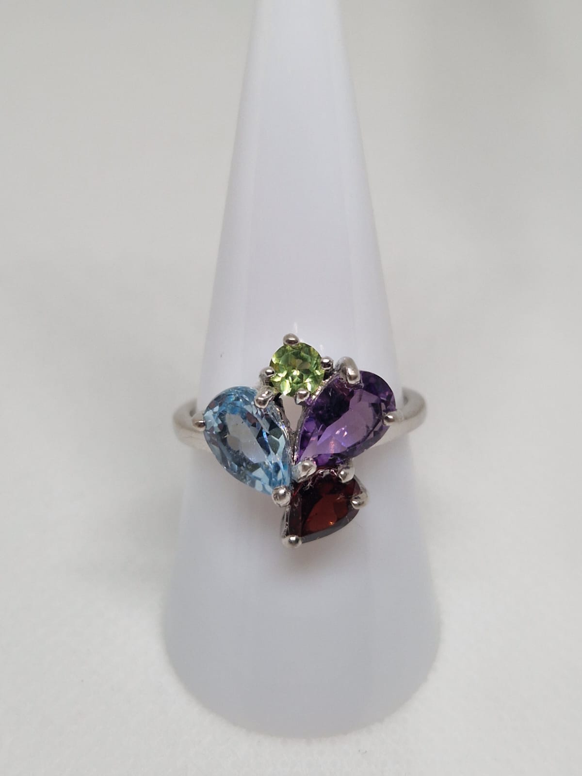 Silver ring with a Topaz, Amethyst, Garnet and Chrysolite inlay