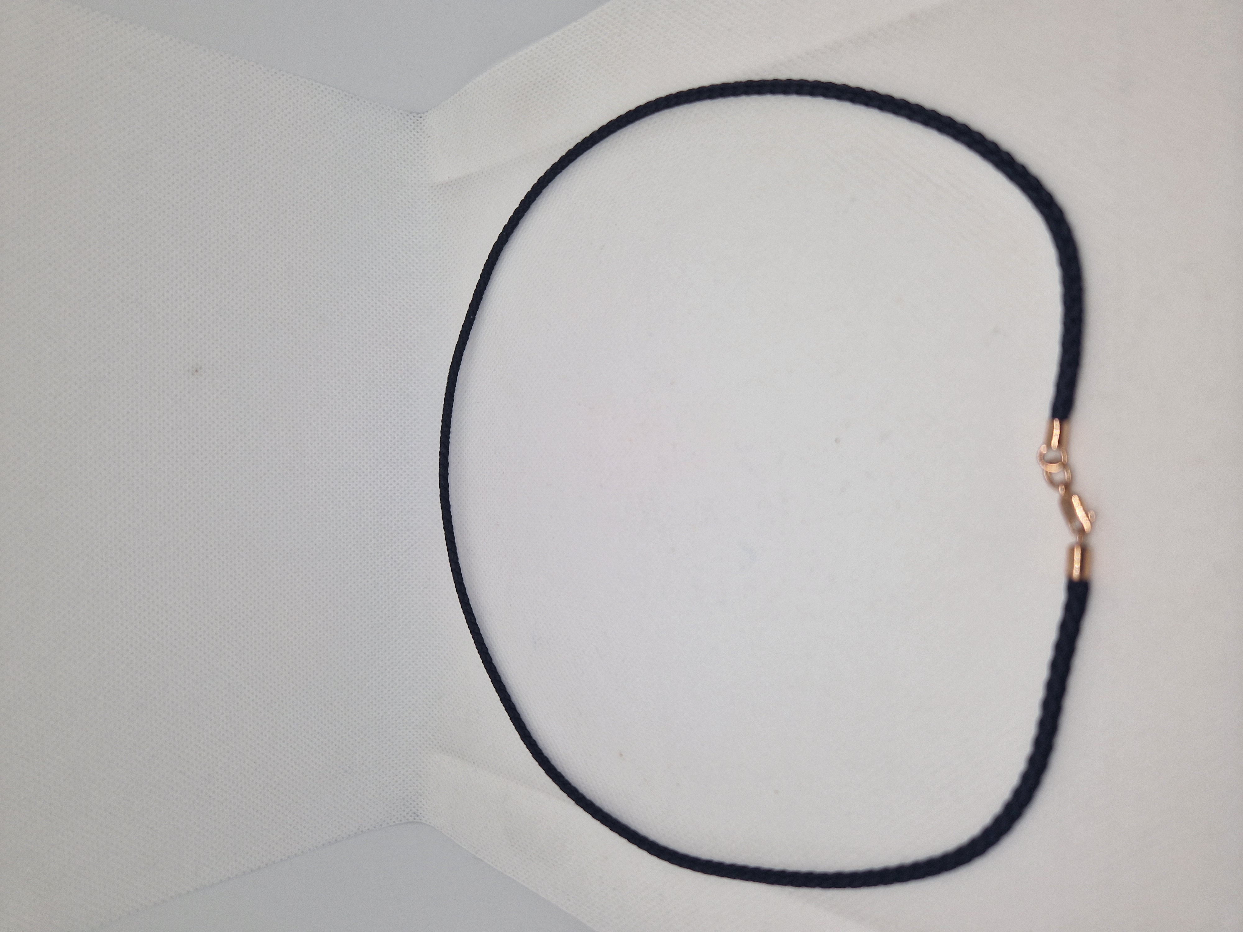 Black syntetic cord with gold ends and a lock