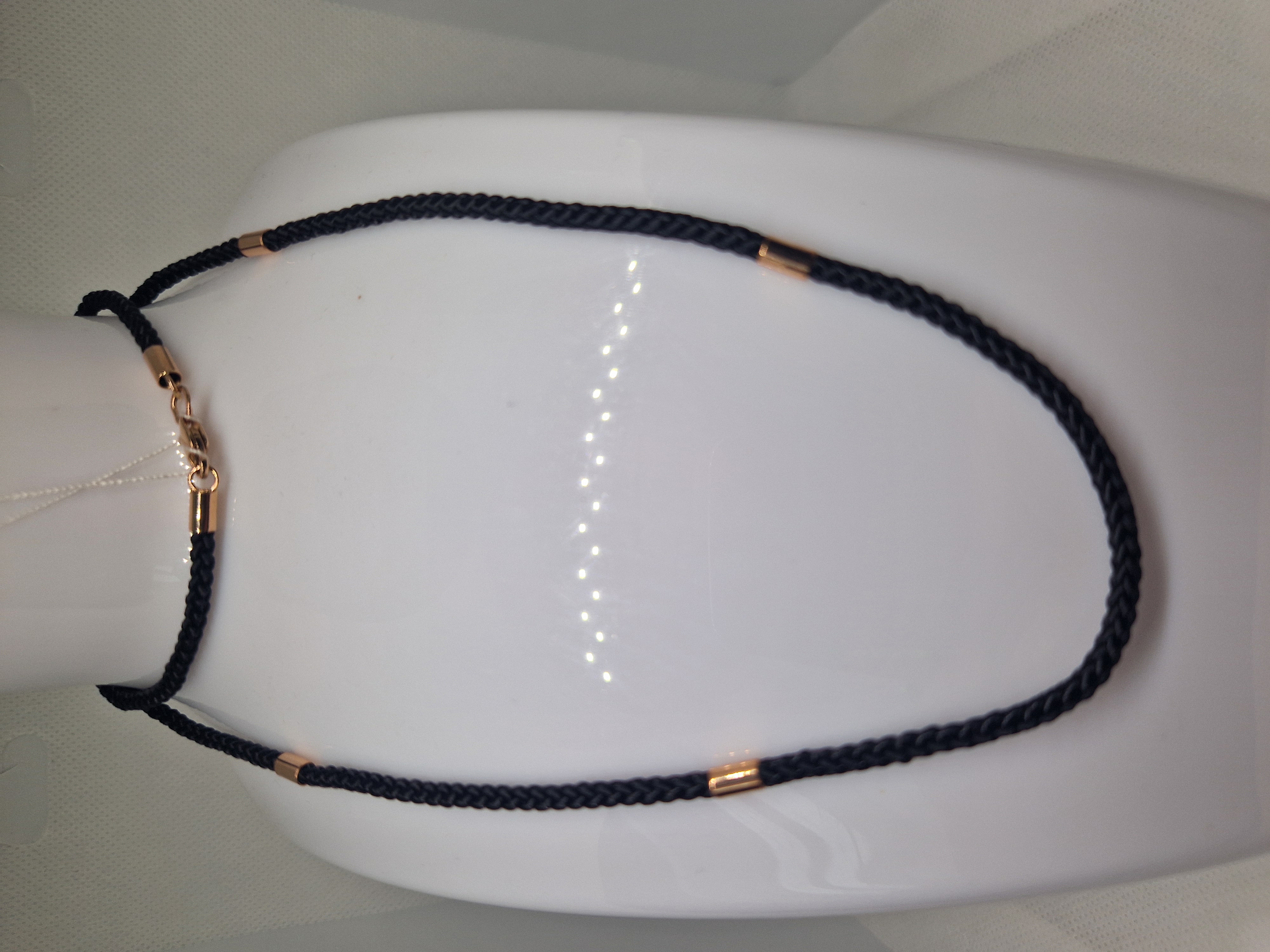 Black syntetic cord with gold insert and a lock