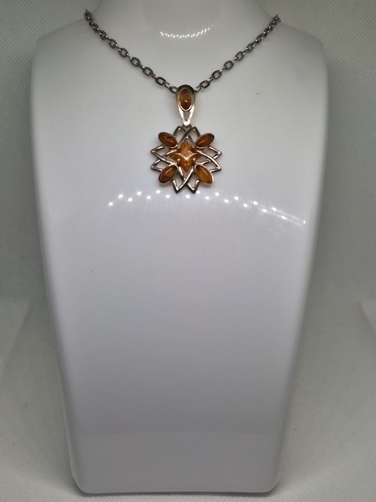 Silver pendant with amber