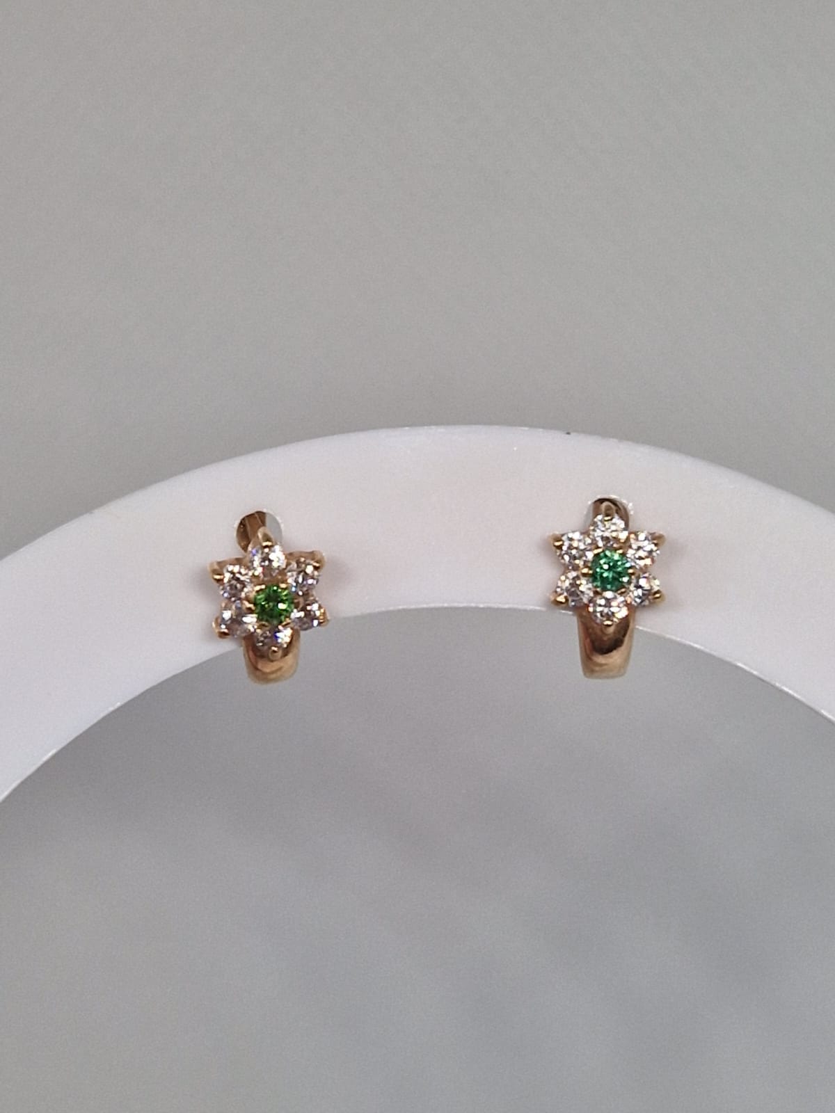 Gold earrings with green gemstone