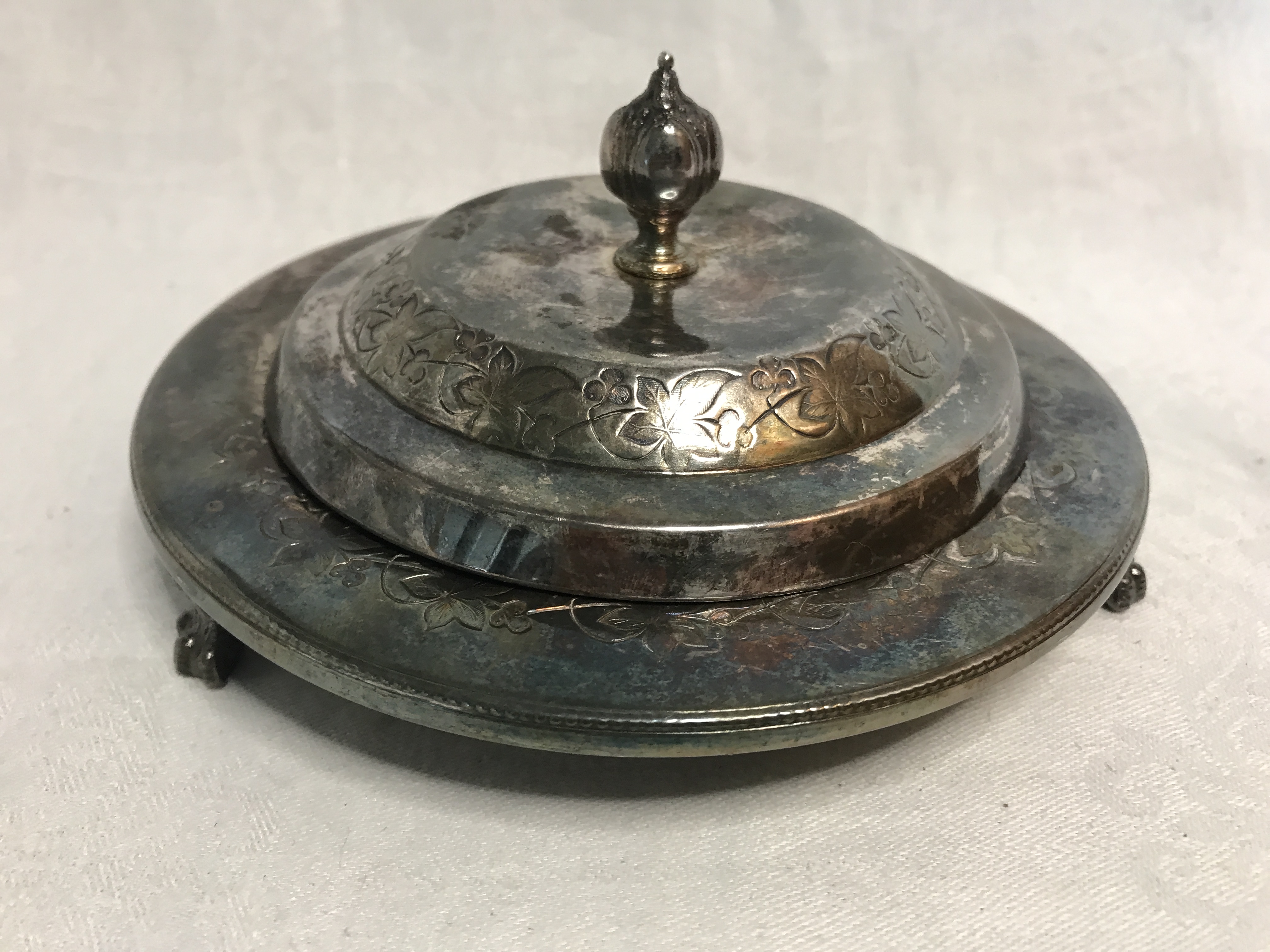 Silver plated covered serving dish on 3 claw foot legs. Stamped F Spiller London