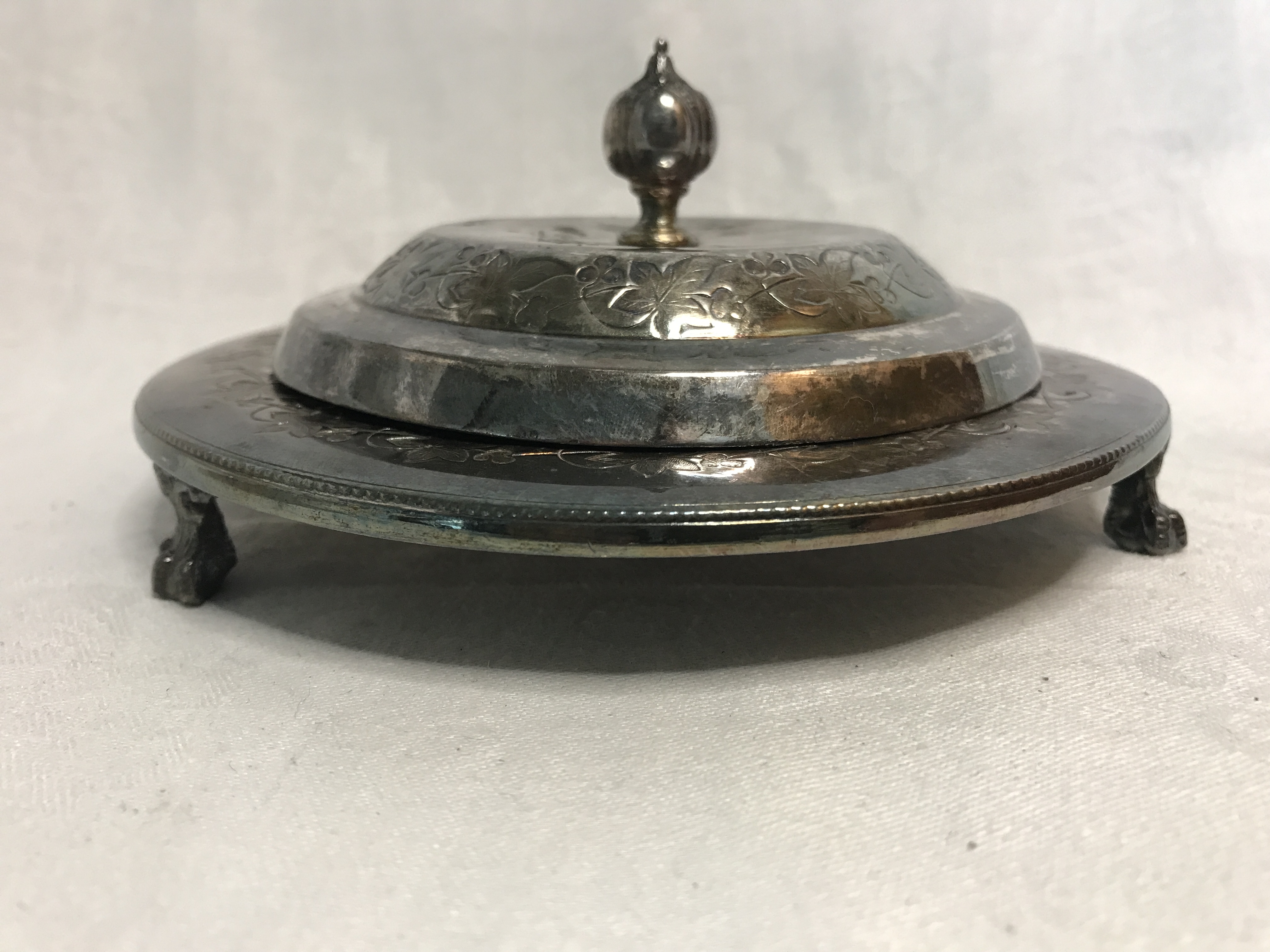 Silver plated covered serving dish on 3 claw foot legs. Stamped F Spiller London