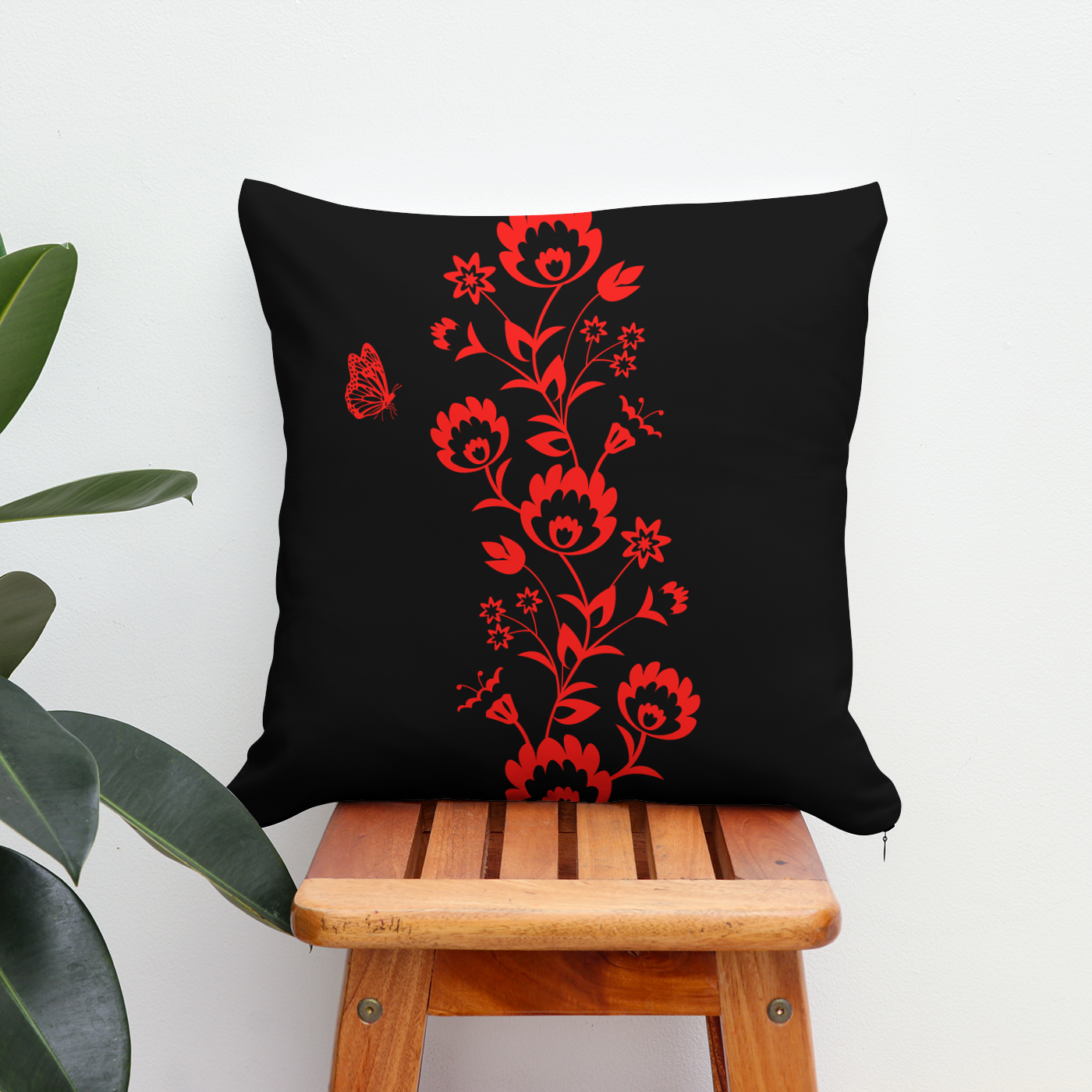 Patio cushion in black with a stunning red floral design through the middle.