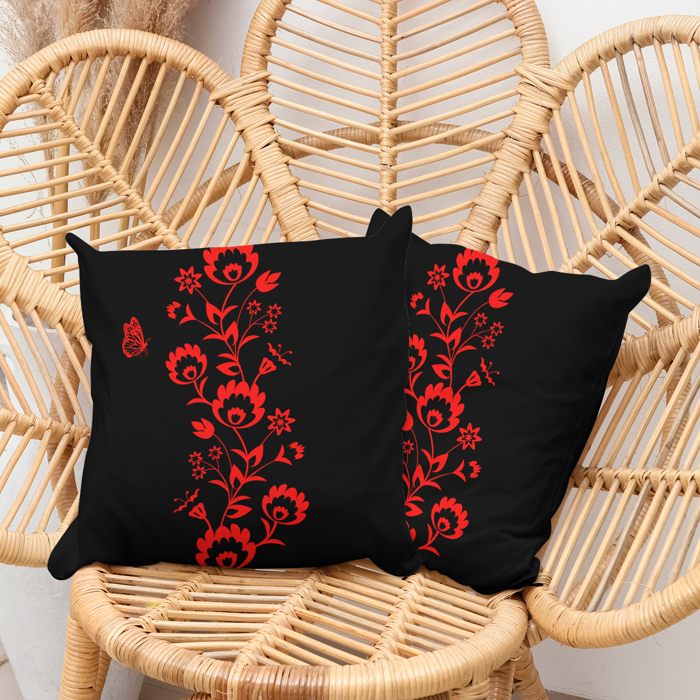 Patio cushion in black with a stunning red floral design through the middle.