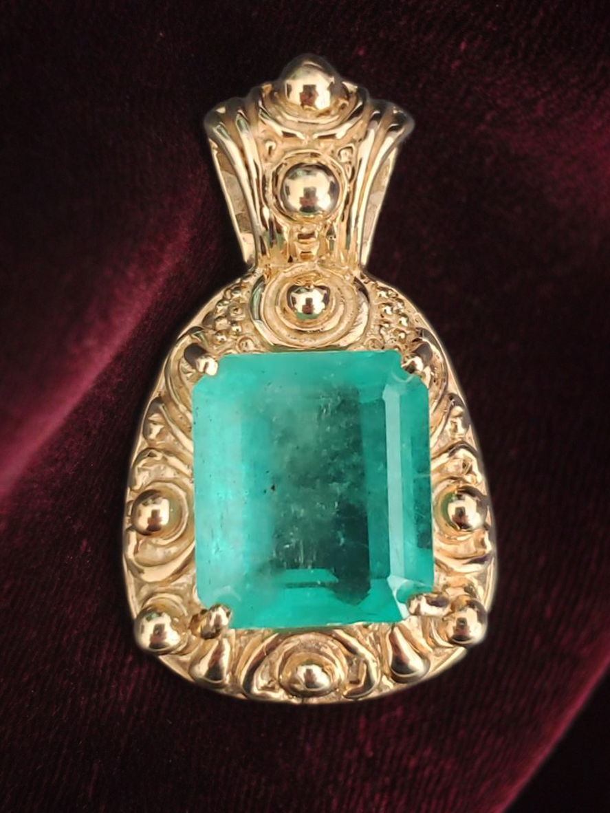 18.02ct. Natural Emerald cut Emerald set in a 14K yellow gold pendant