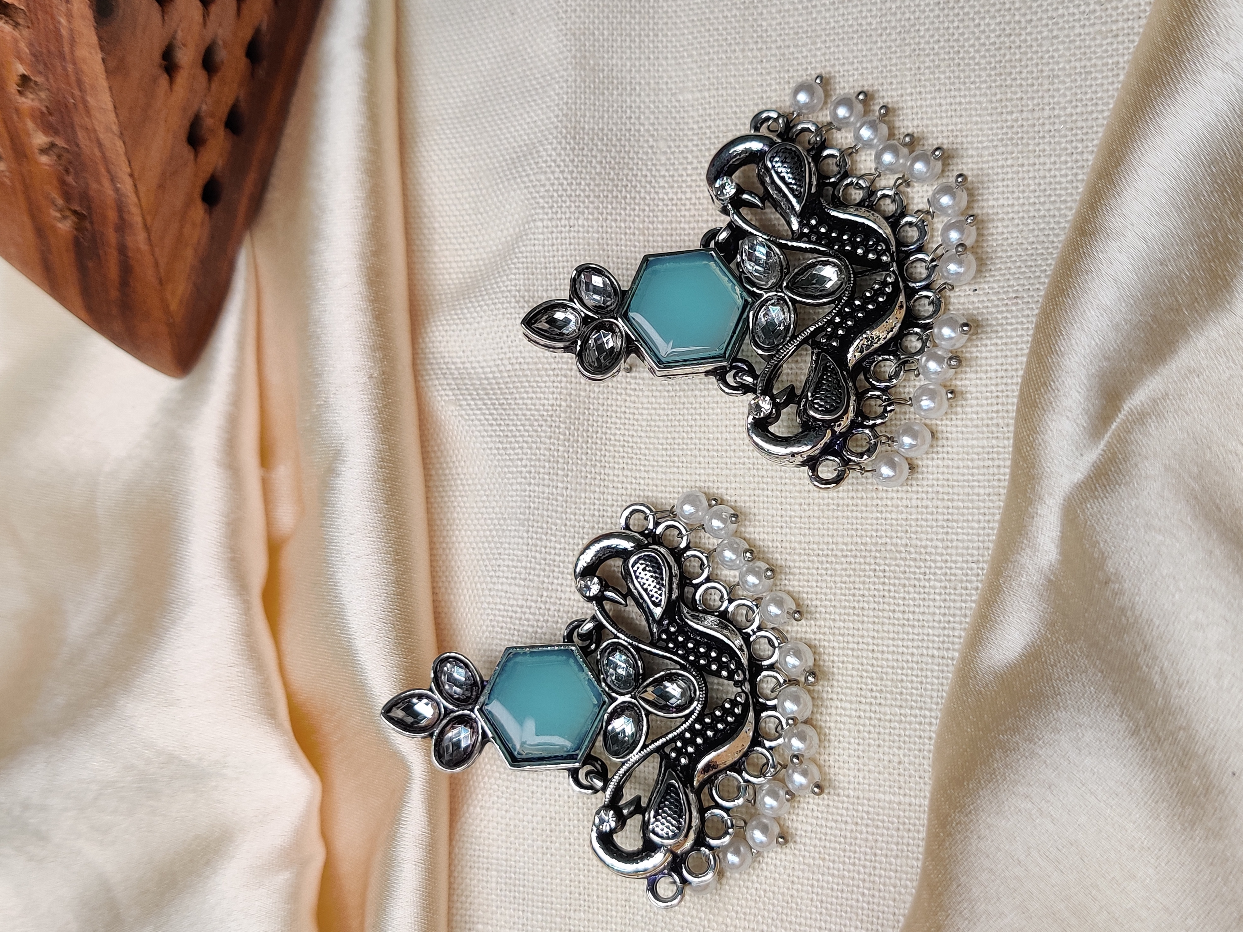 Silver peacock earrings with blue stone & pearl beads