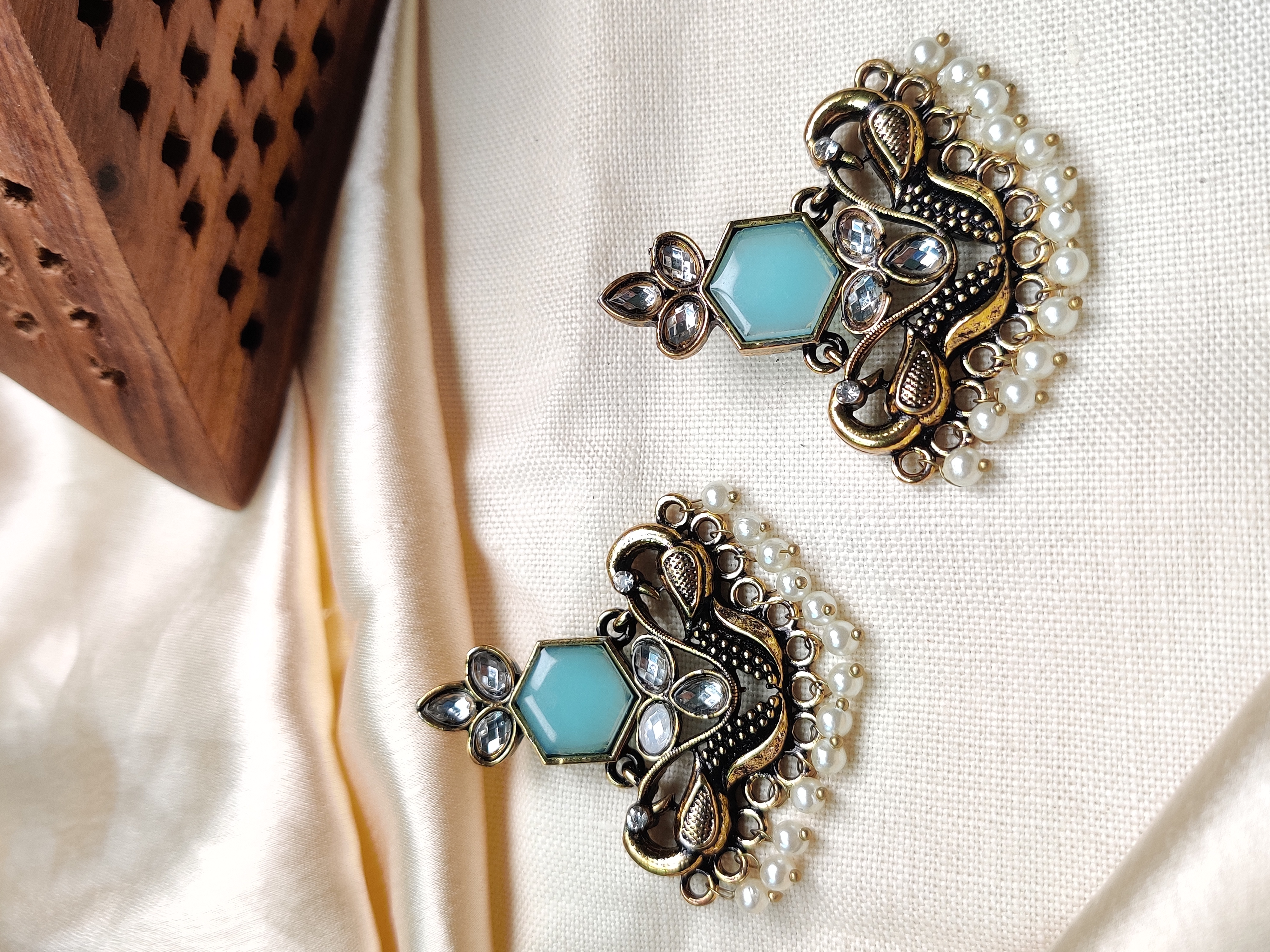 Golden peacock earrings with blue stone & pearl drops 