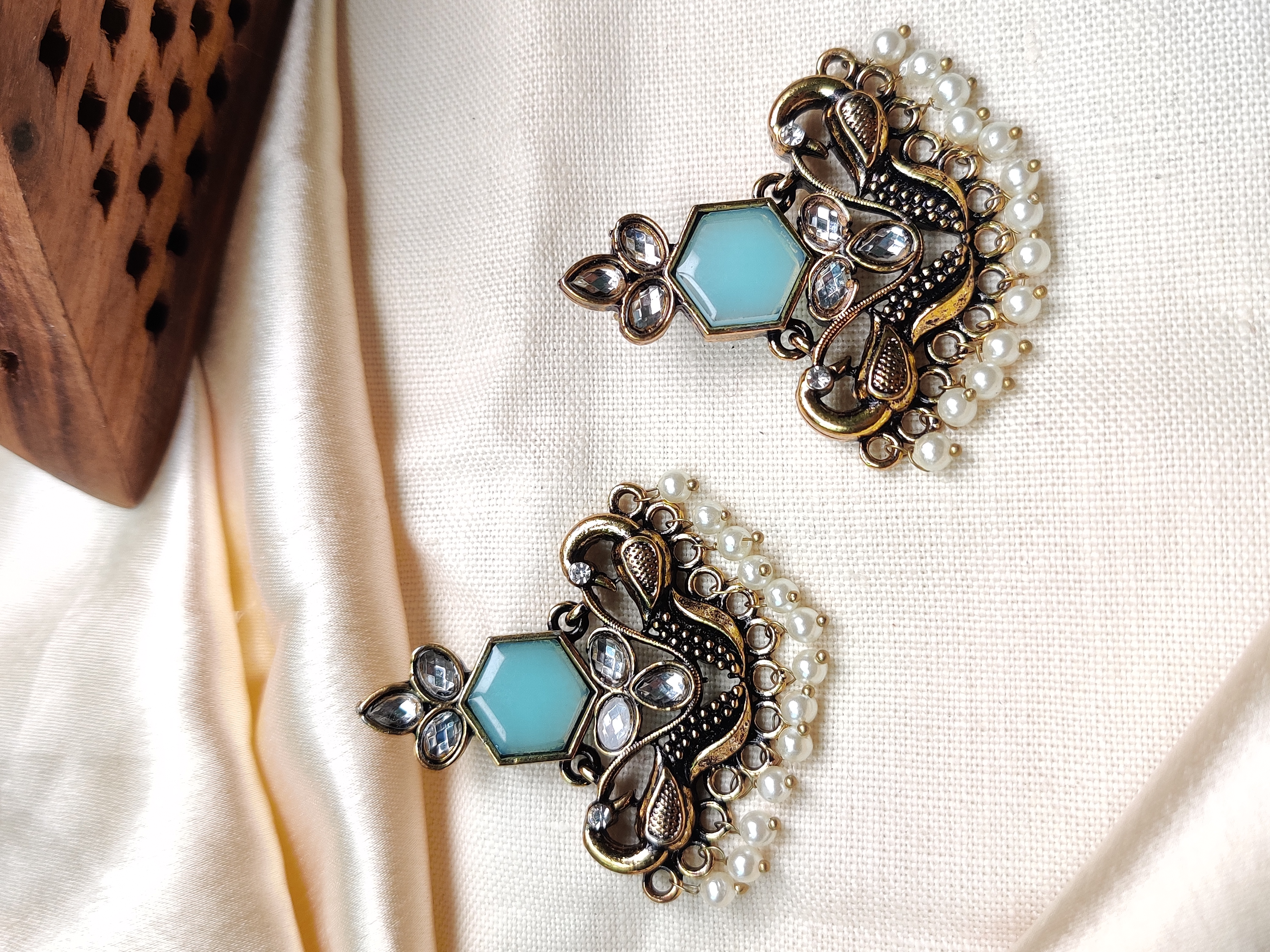 Golden peacock earrings with blue stone & pearl drops 