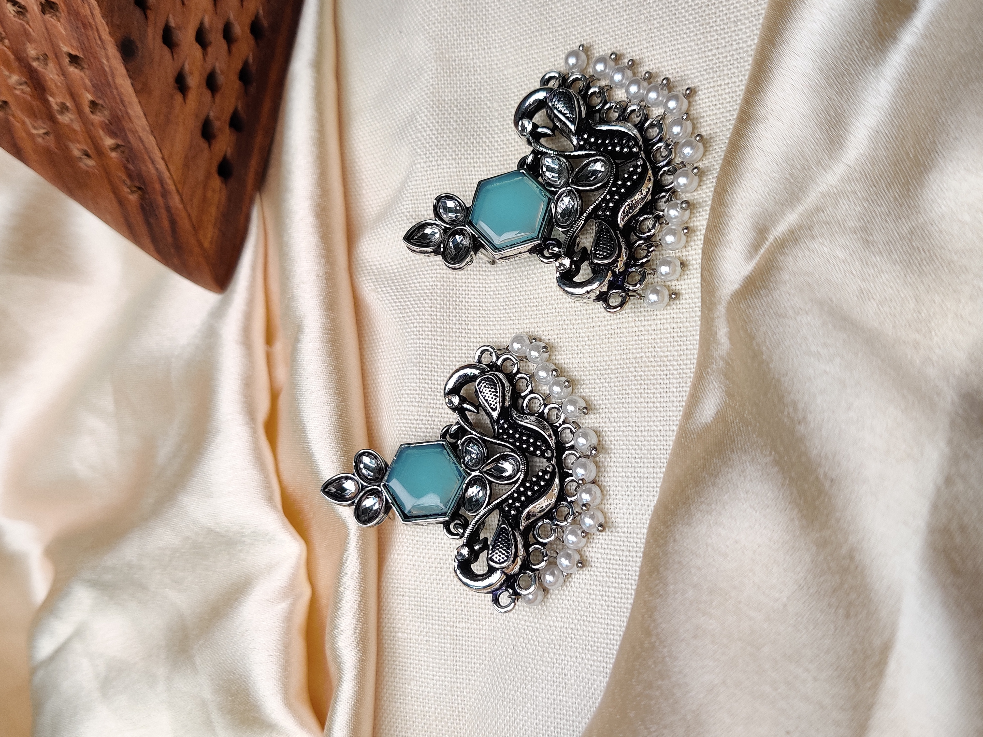 Silver peacock earrings with blue stone & pearl beads