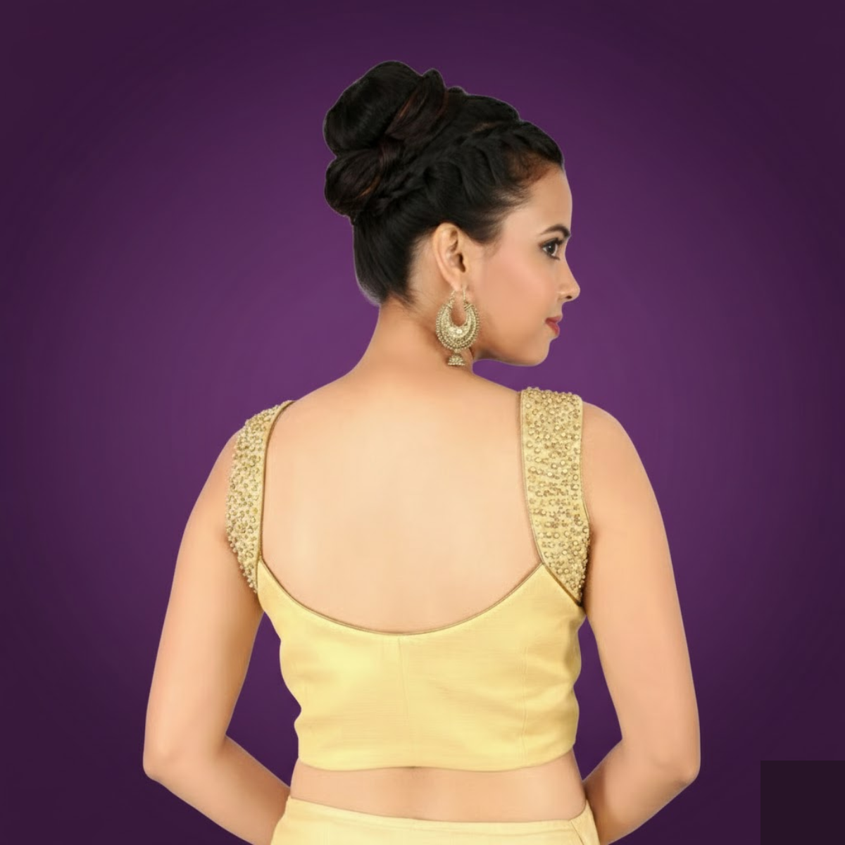 Designer gold blouse with embroidered arm band and side opening.
