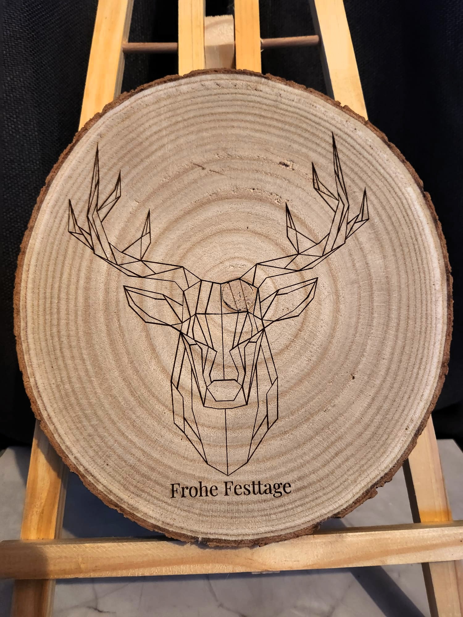 Holzscheibe mit Lasergravur „Geometrischer Hirsch – Frohe Festtage“
