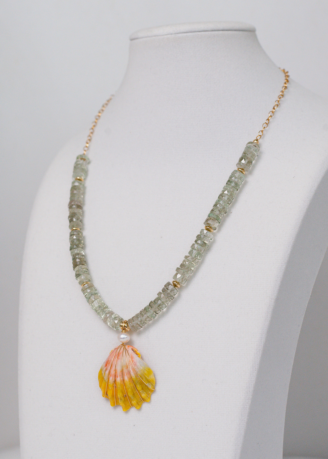 Green amethyst gemstones  highlight Hawaiian Sunrise Shell