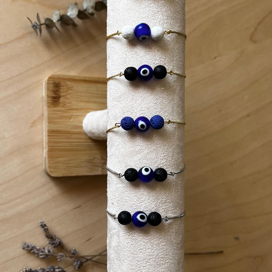 Pulseira Difusora – Aço Inox Dourado, Pedra Vulcânica Azul e Olho Grego