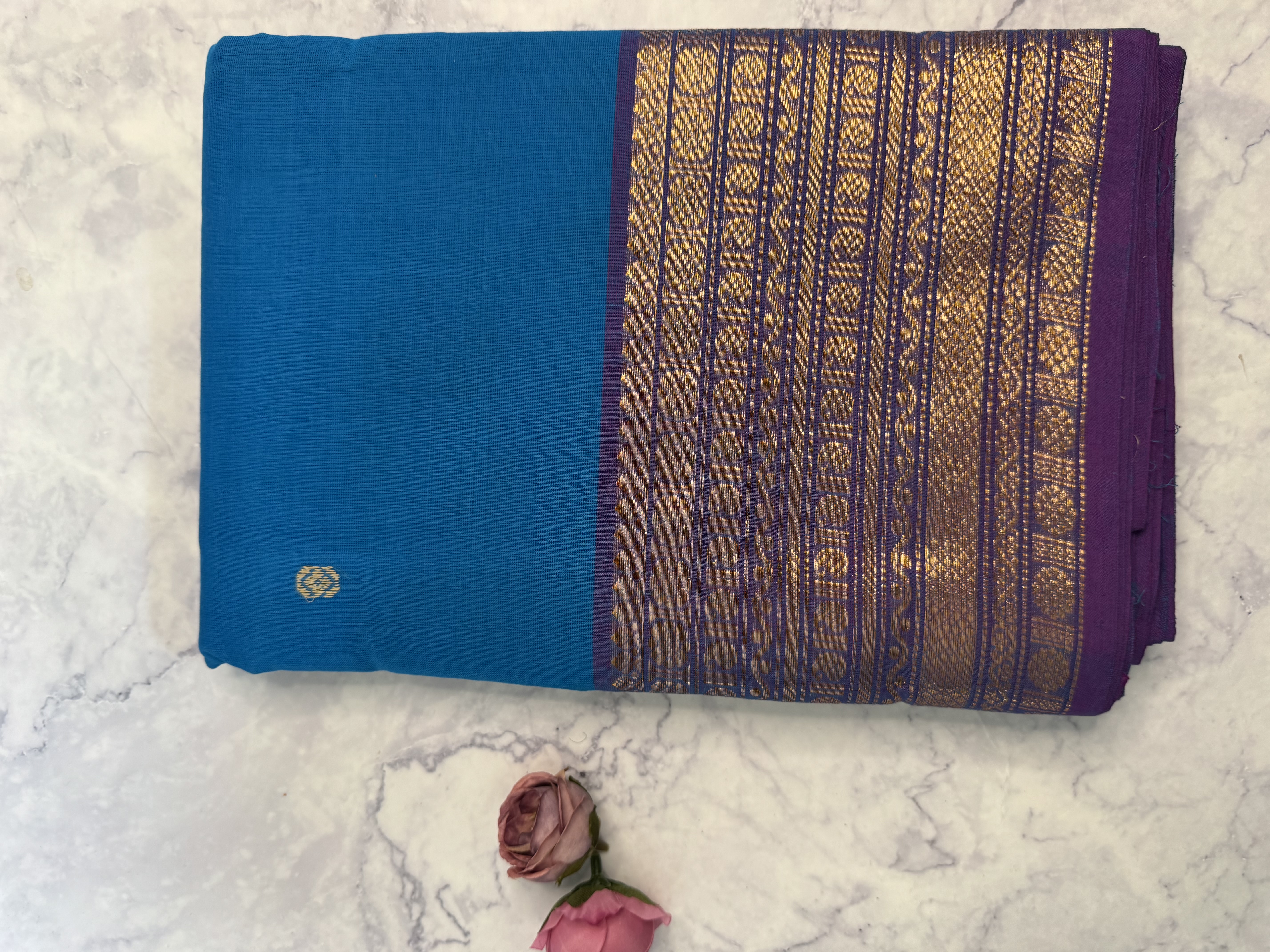 Bright blue cotton saree with gold and copper border