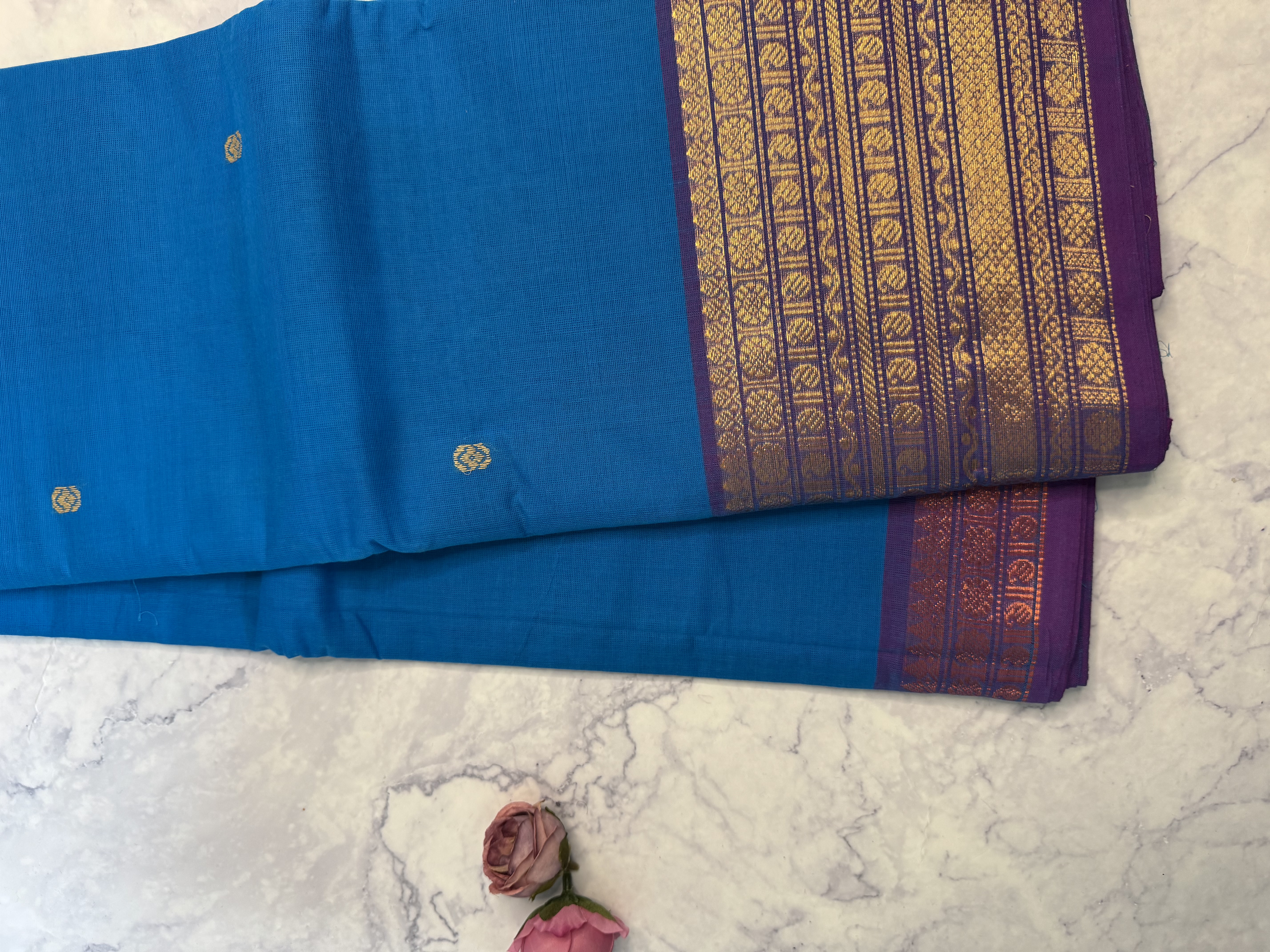 Bright blue cotton saree with gold and copper border