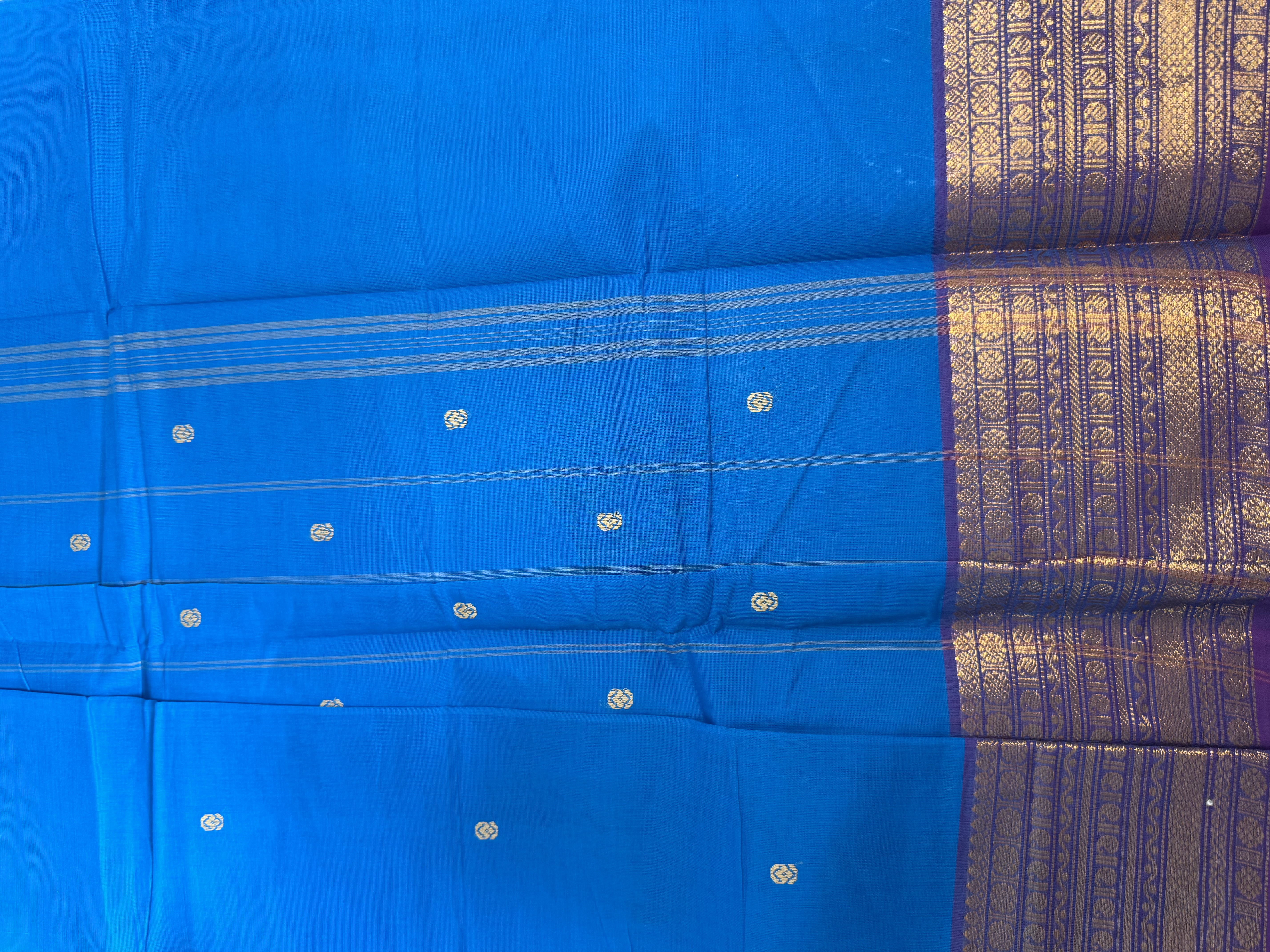 Bright blue cotton saree with gold and copper border