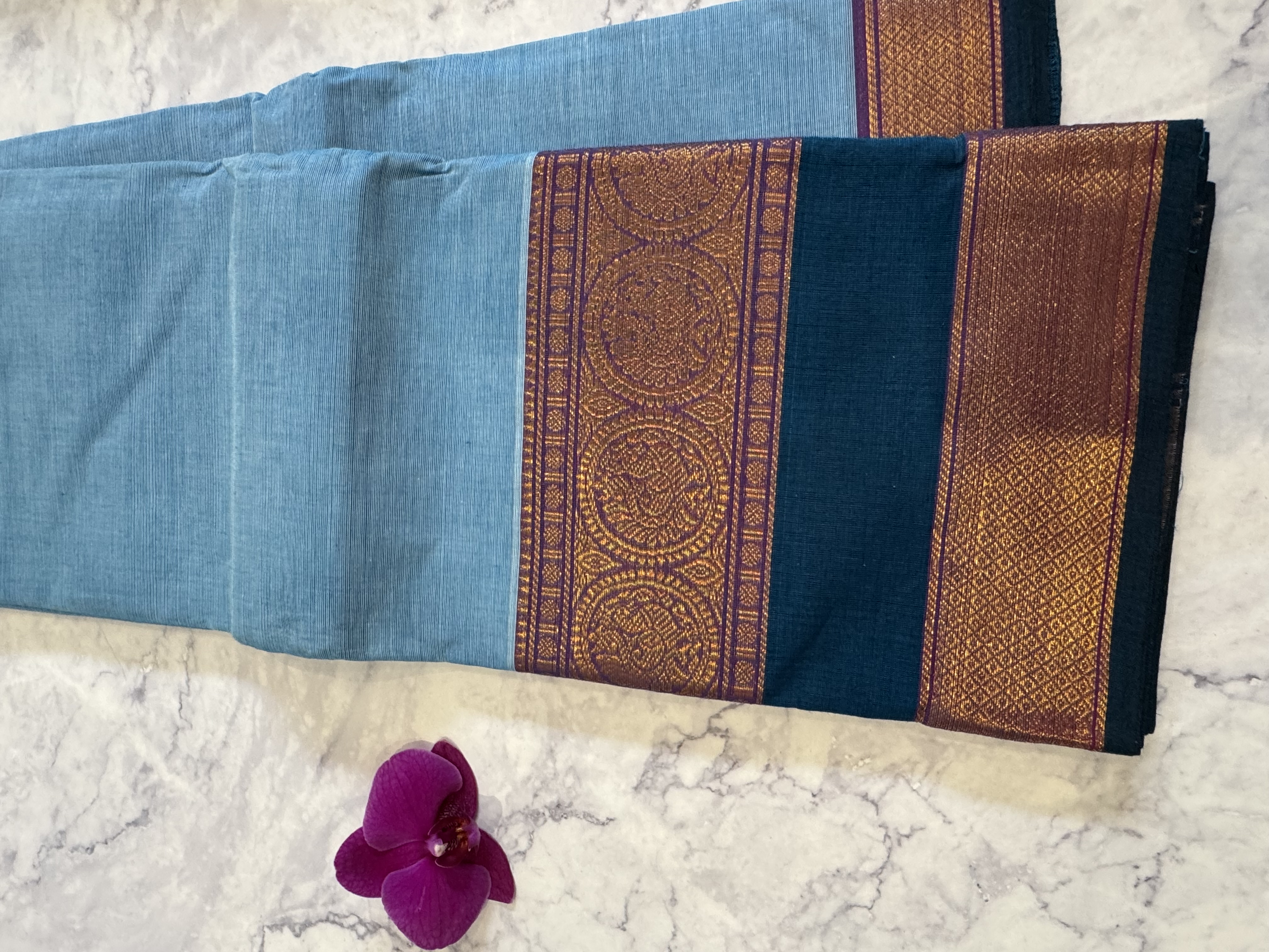 Sky blue cotton saree with teal border