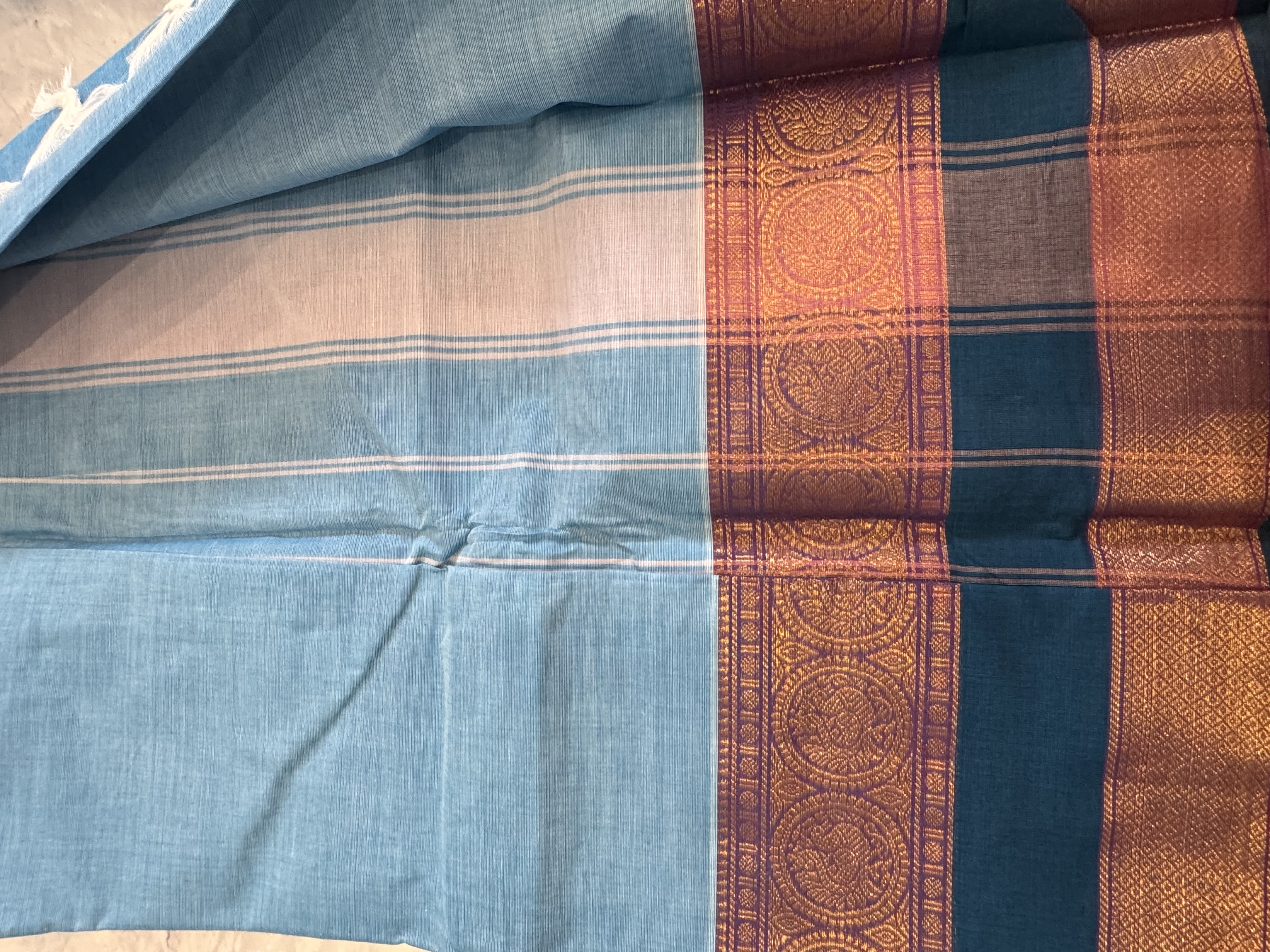 Sky blue cotton saree with teal border