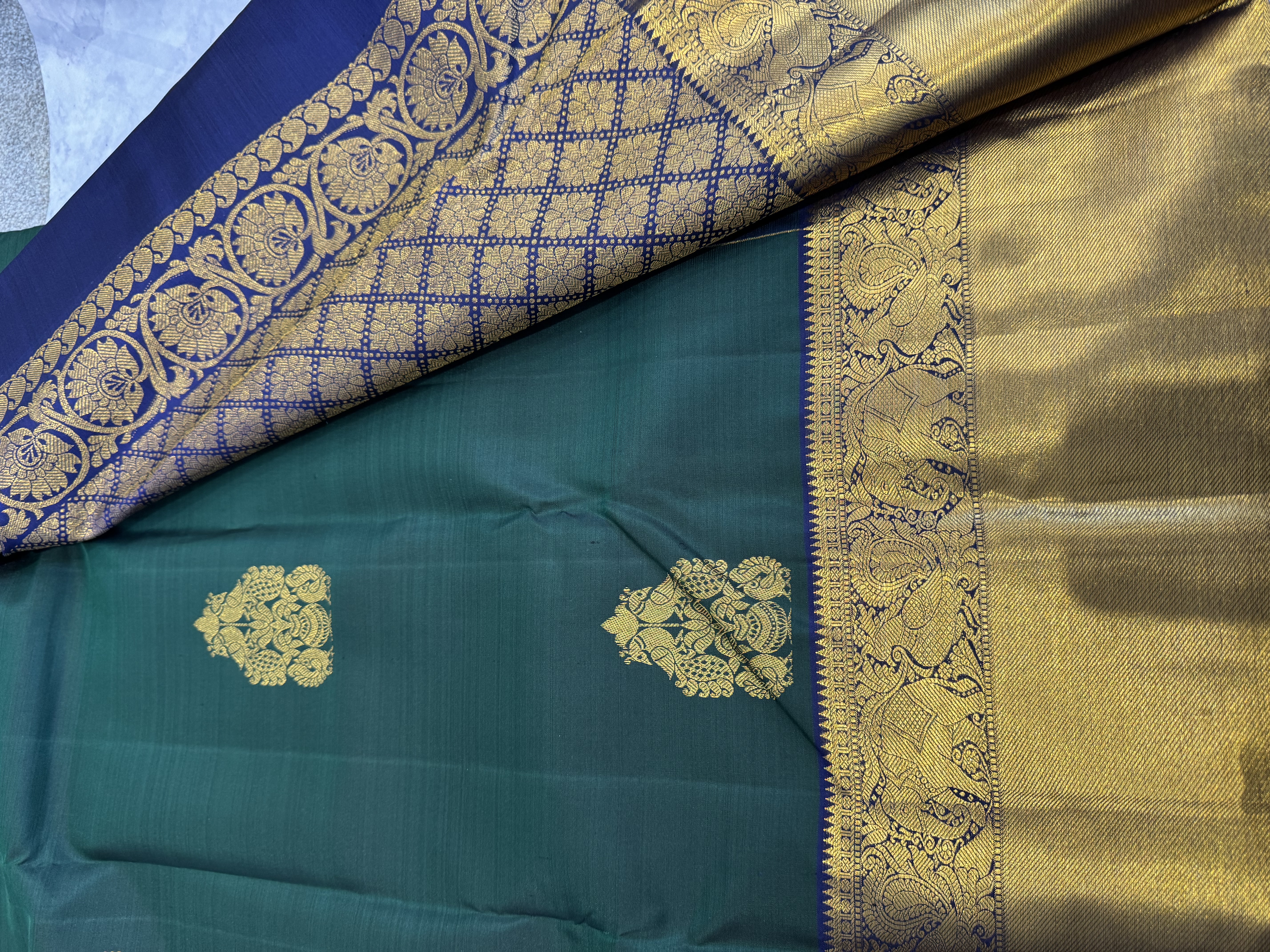 Forest green pure silk saree with navy blue blouse
