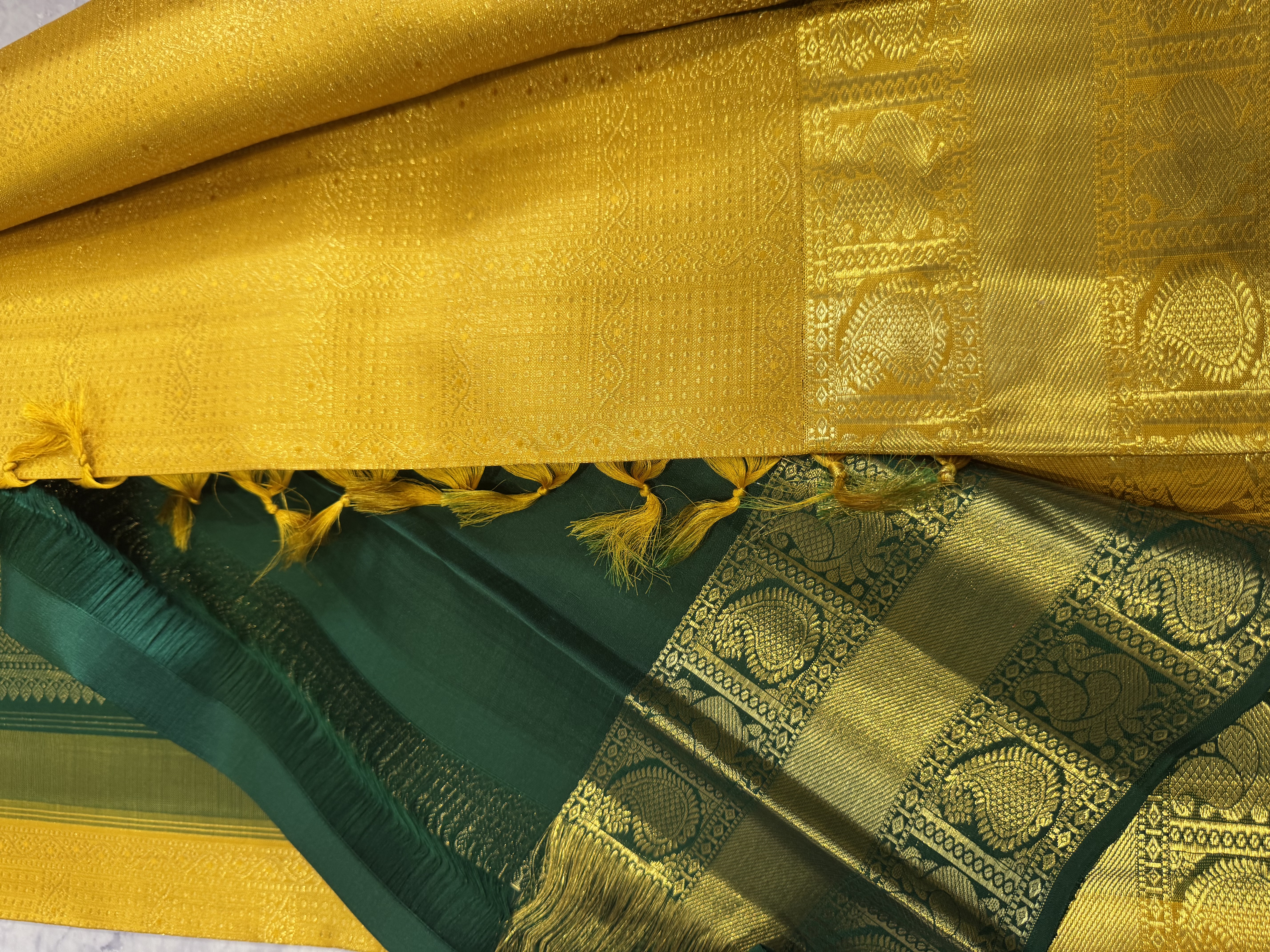 Yellow pure silk saree with forest green blouse