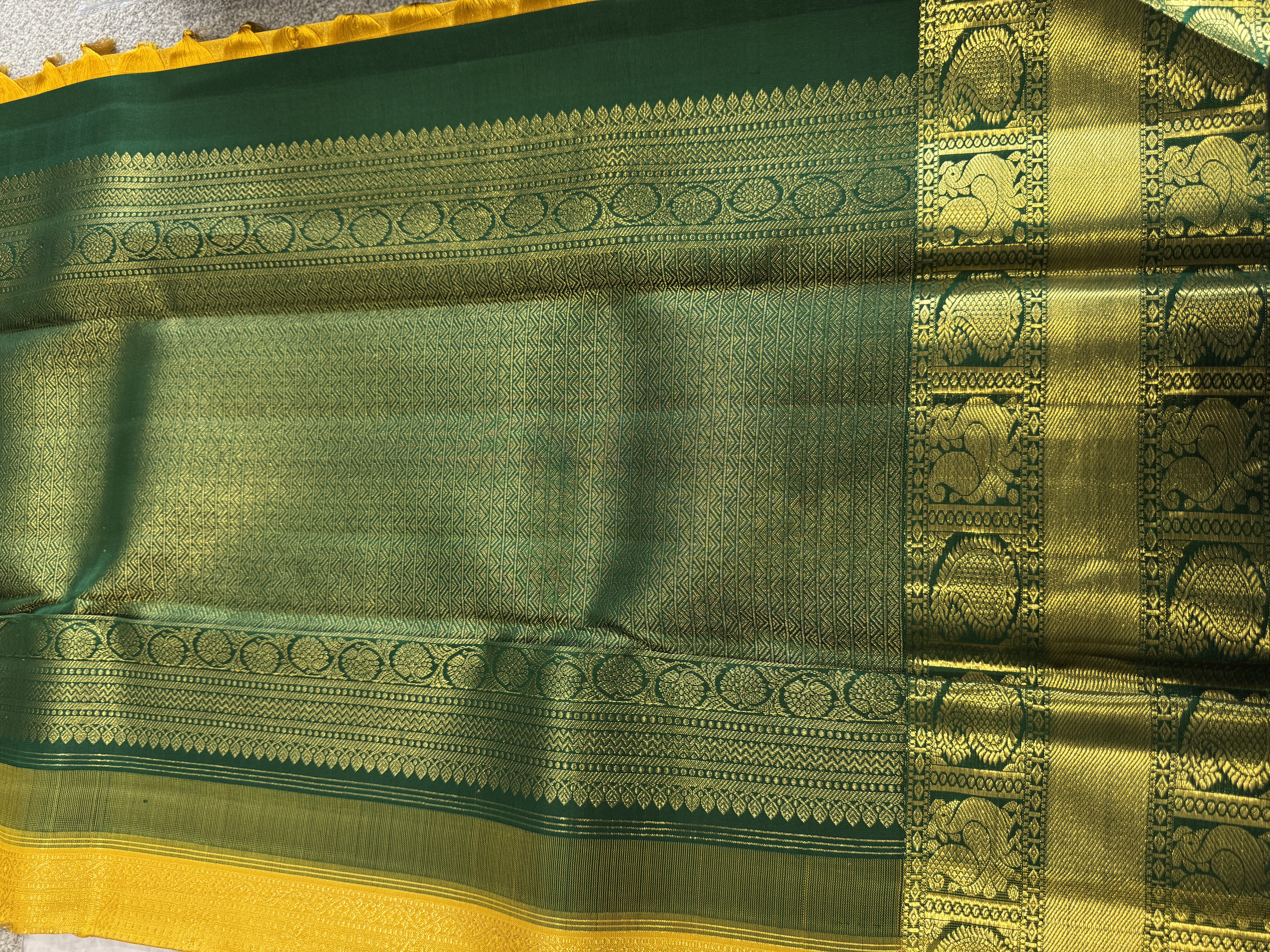 Yellow pure silk saree with forest green blouse